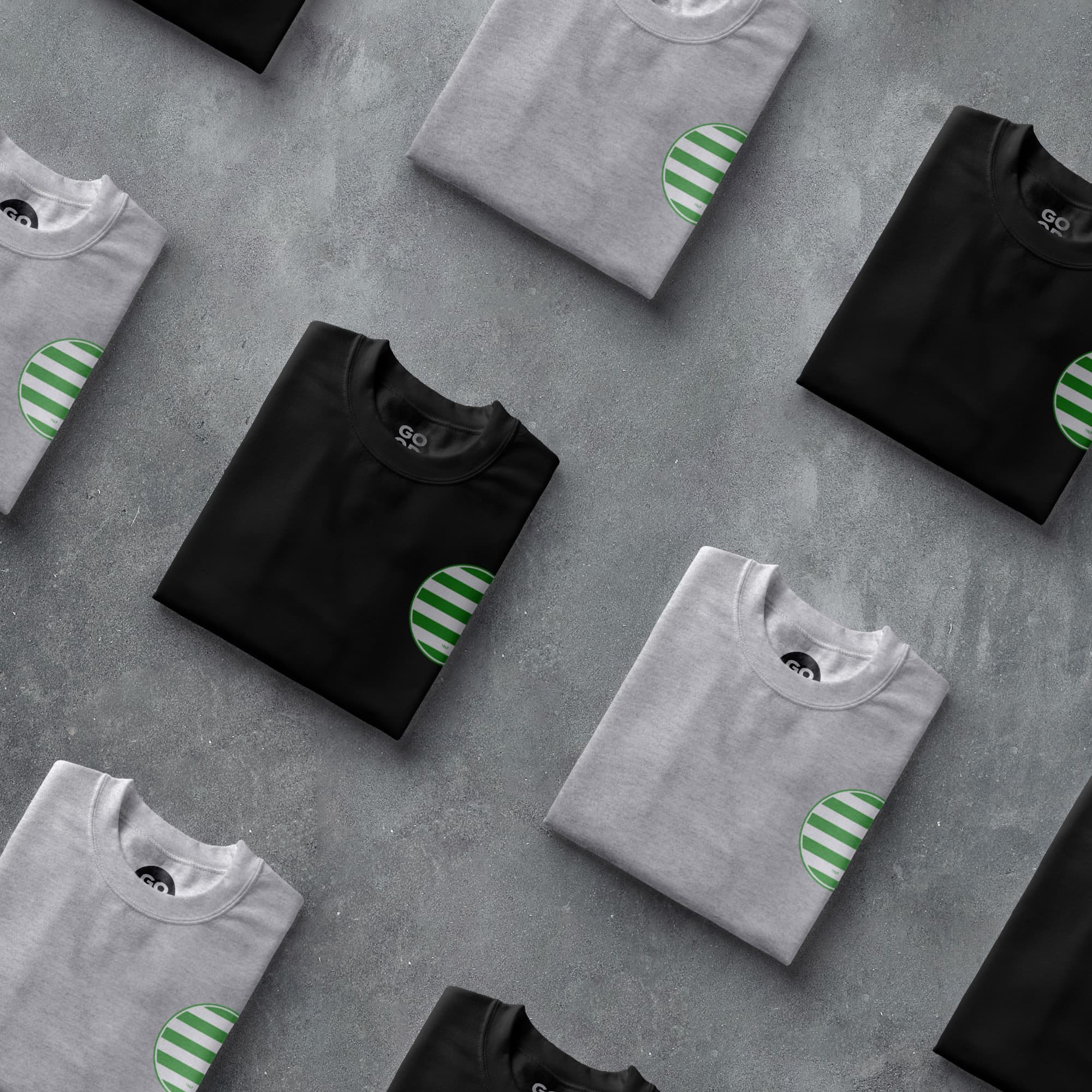a group of t - shirts with green and white stripes