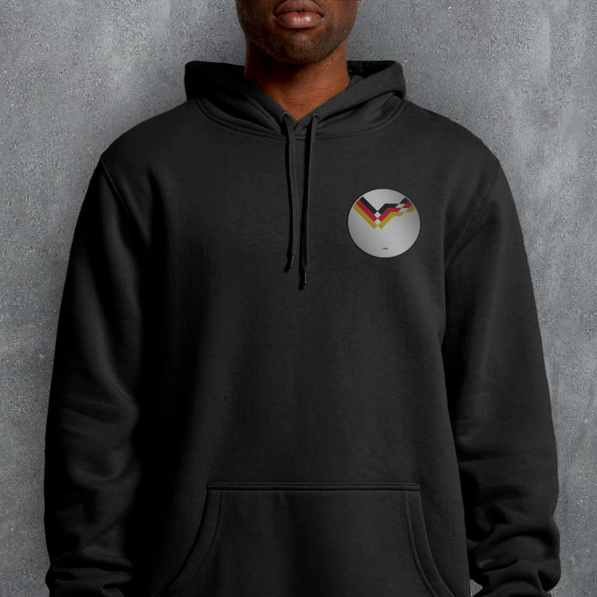 a man wearing a black hoodie with a rainbow logo on it