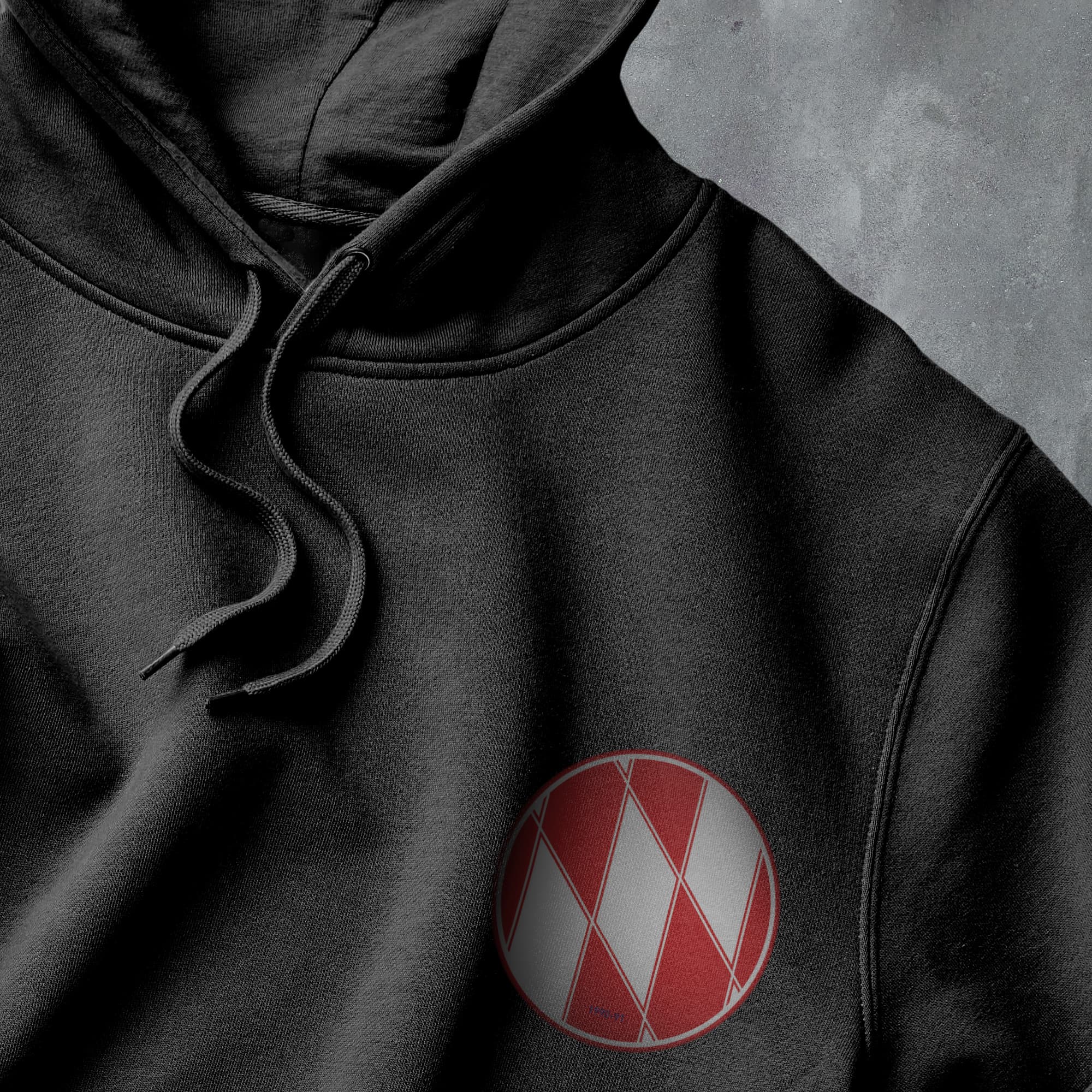 a black hoodie with a red and white logo