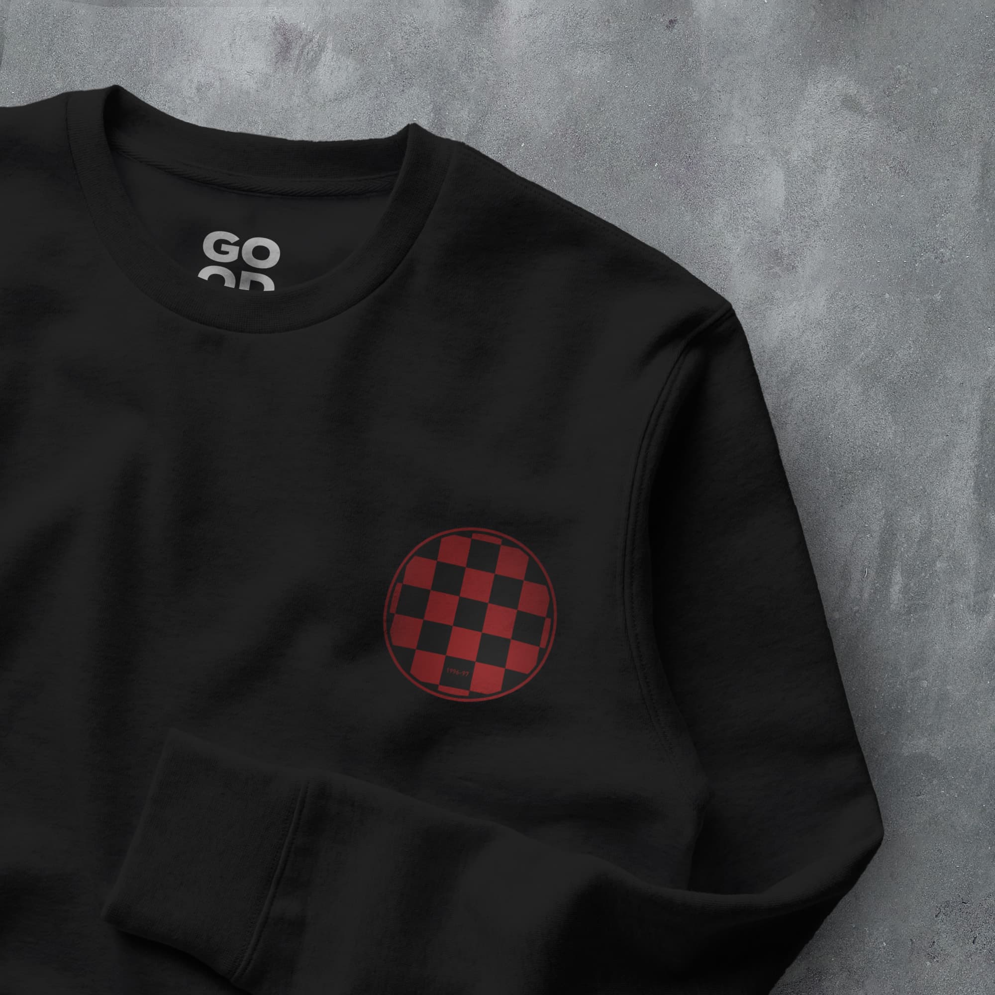 a black sweatshirt with a red and black checkered design