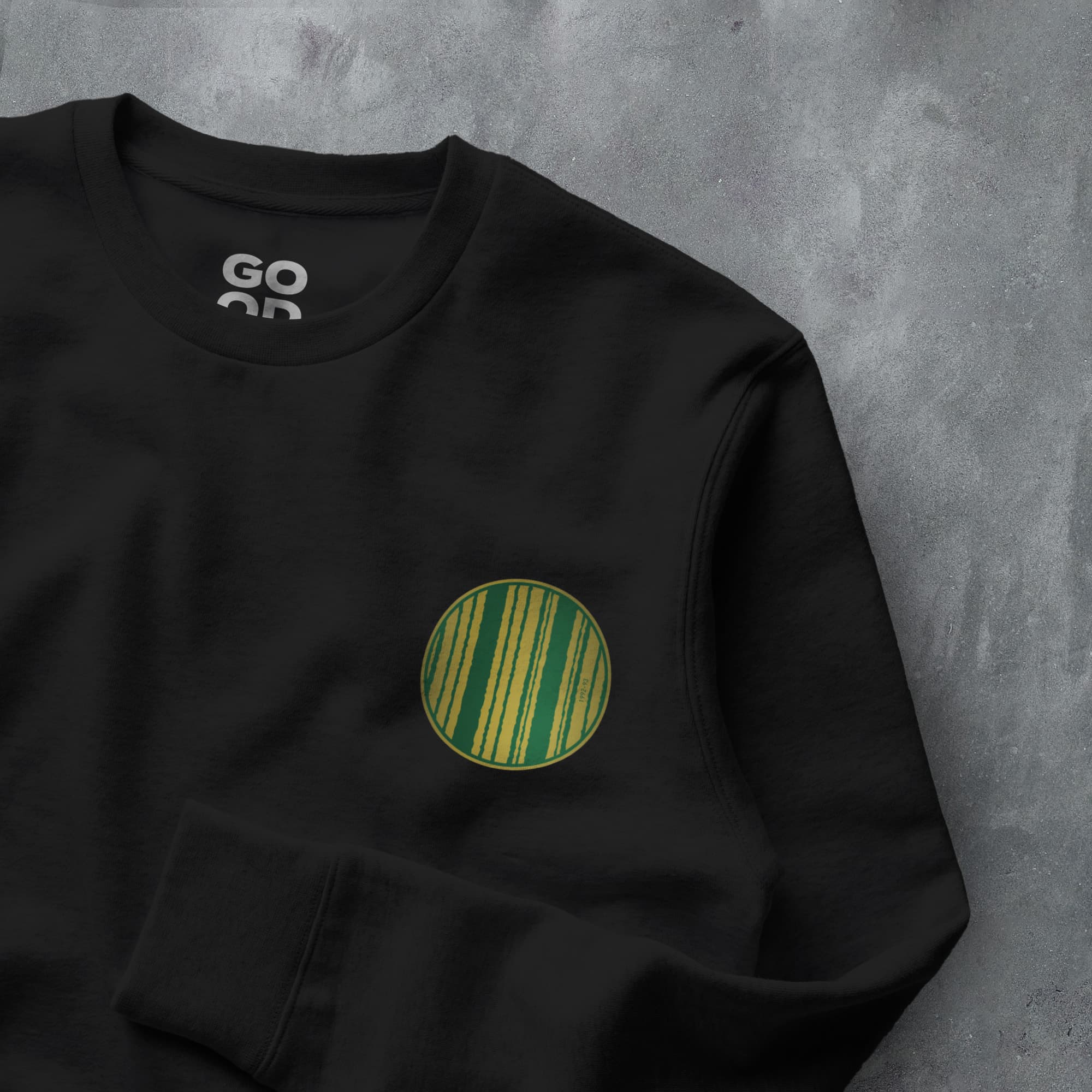 a black sweatshirt with a green circle on it