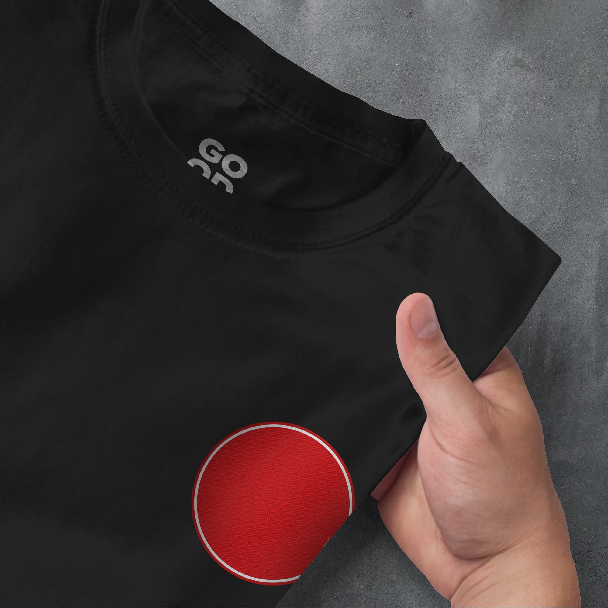 a person pointing at a black shirt with a red circle on it