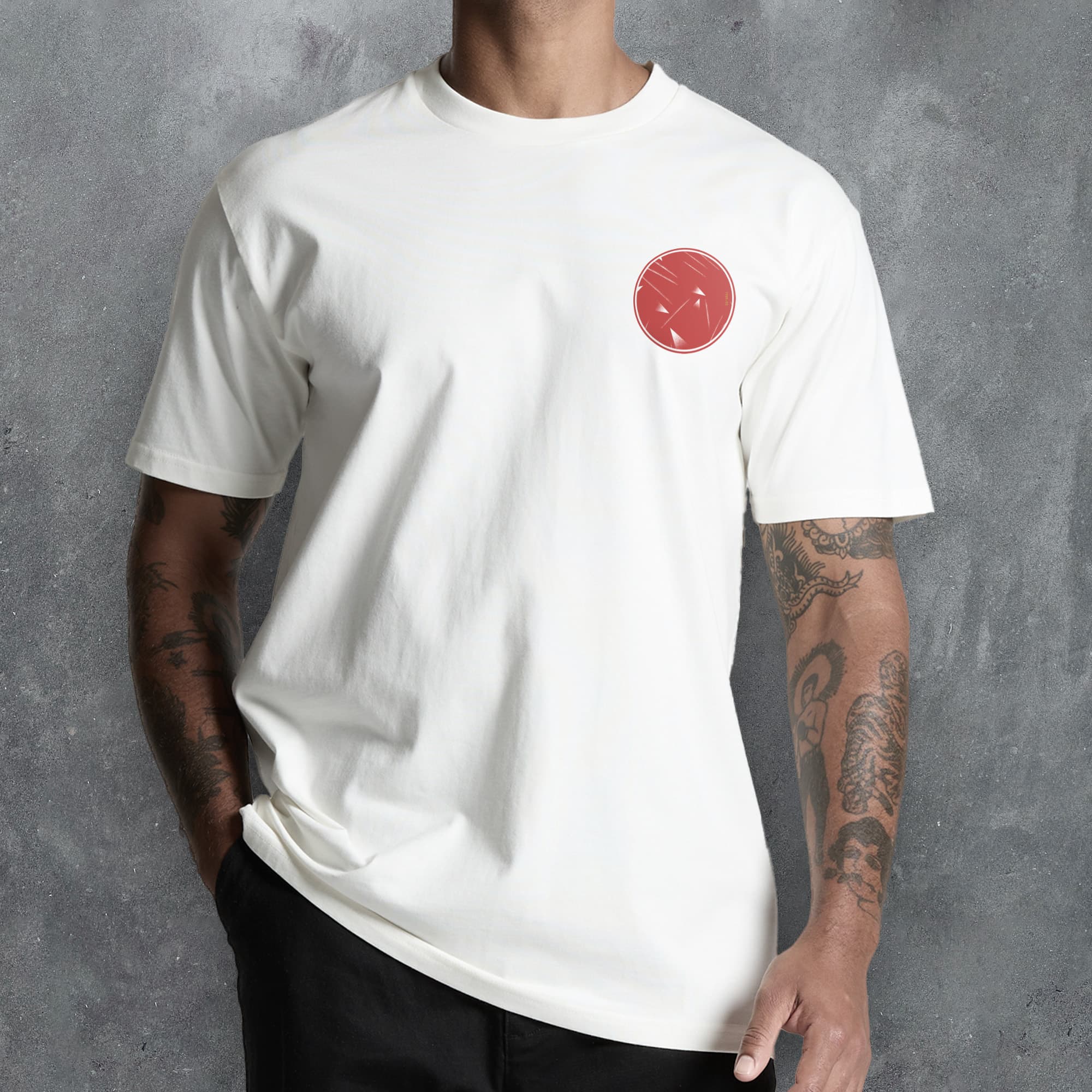 a man wearing a white t - shirt with a red smiley face on it