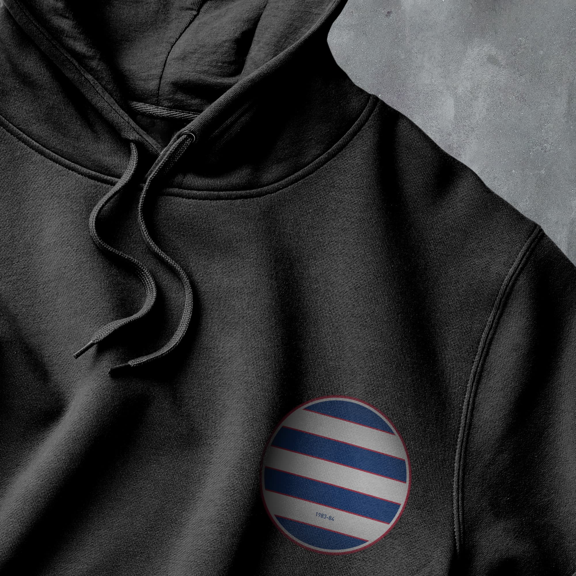 a black hoodie with a red, white and blue circle on it