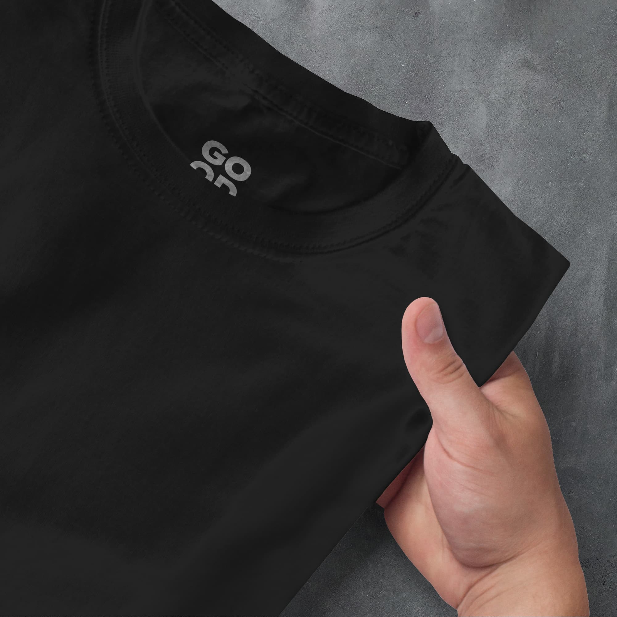 a hand pointing at a black shirt with the word ao on it