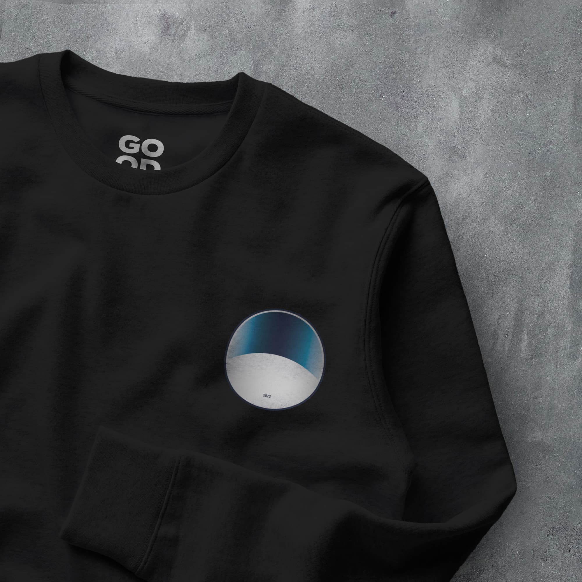 a black sweatshirt with a white and blue circle on it