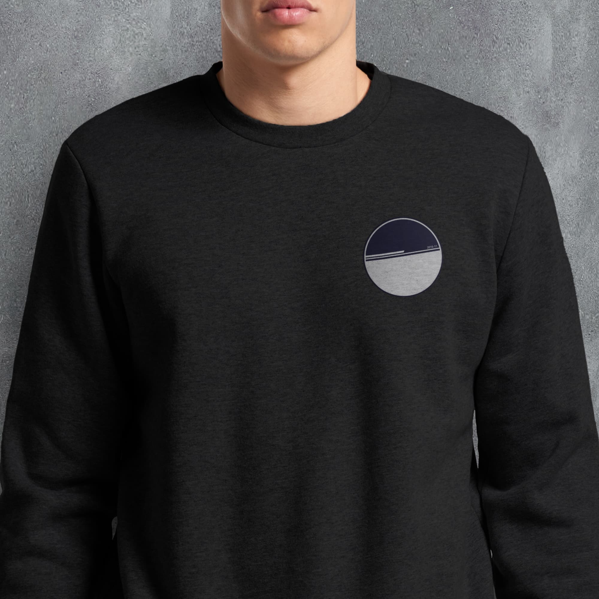 a man wearing a black sweatshirt with a white circle on it
