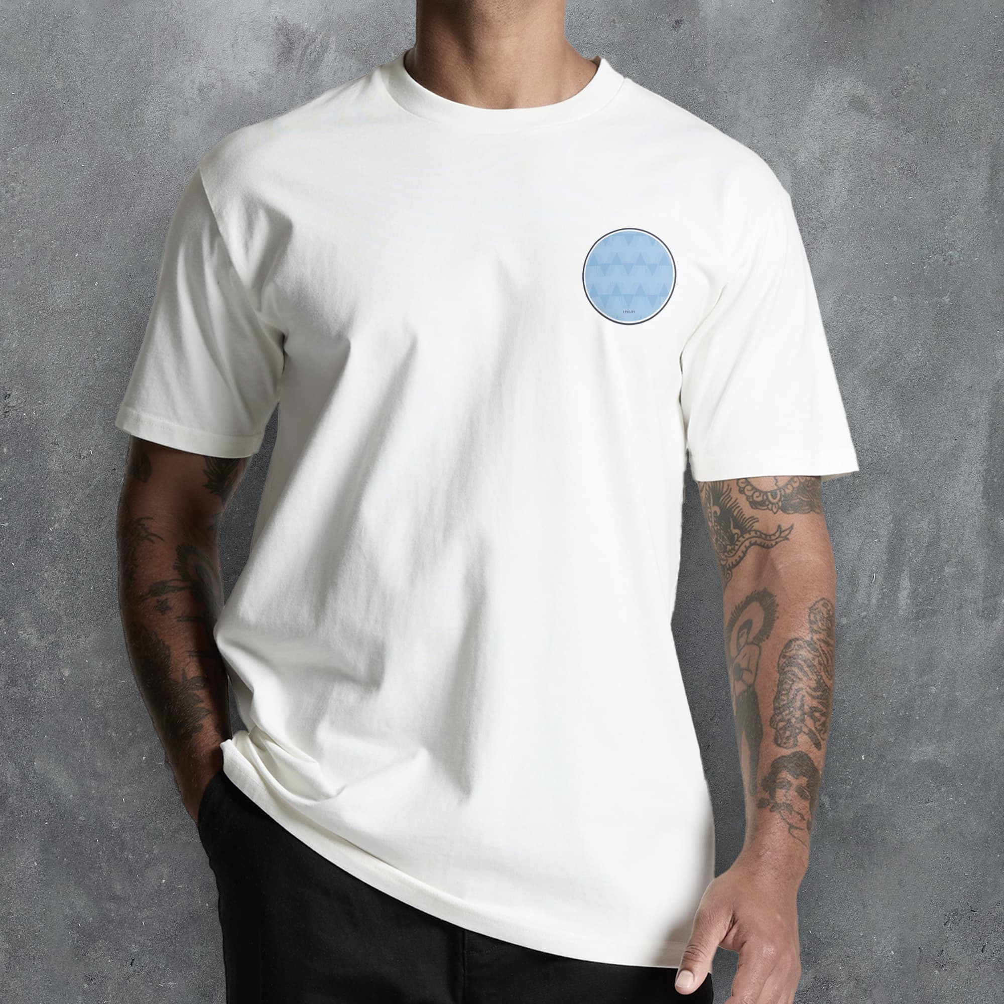 a man wearing a white t - shirt with a blue circle on it
