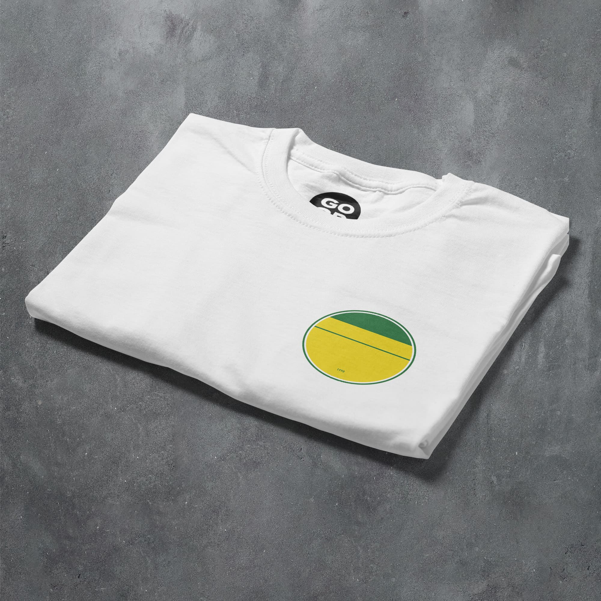 a white t - shirt with a green and yellow circle on it