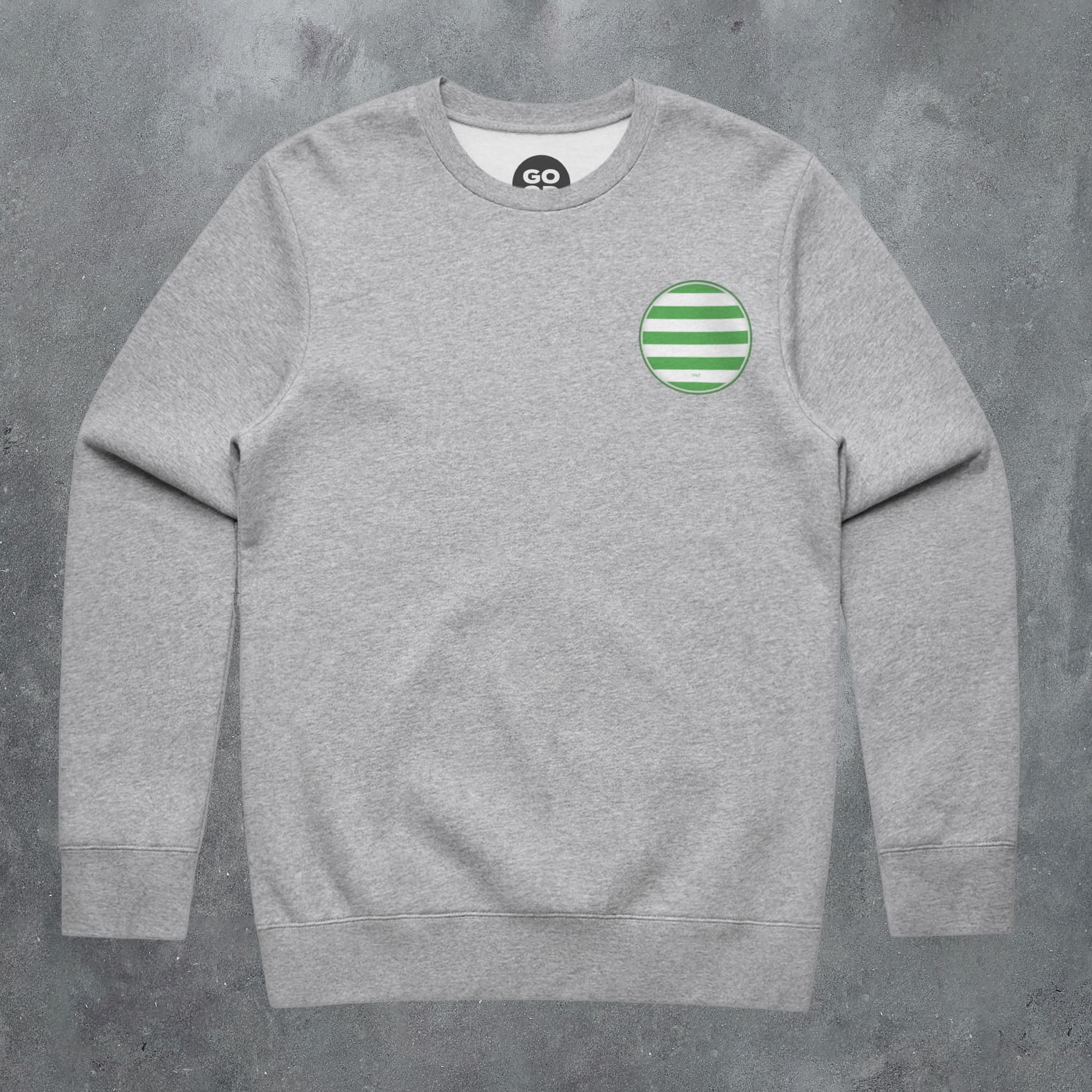 a grey sweatshirt with a green circle on the chest