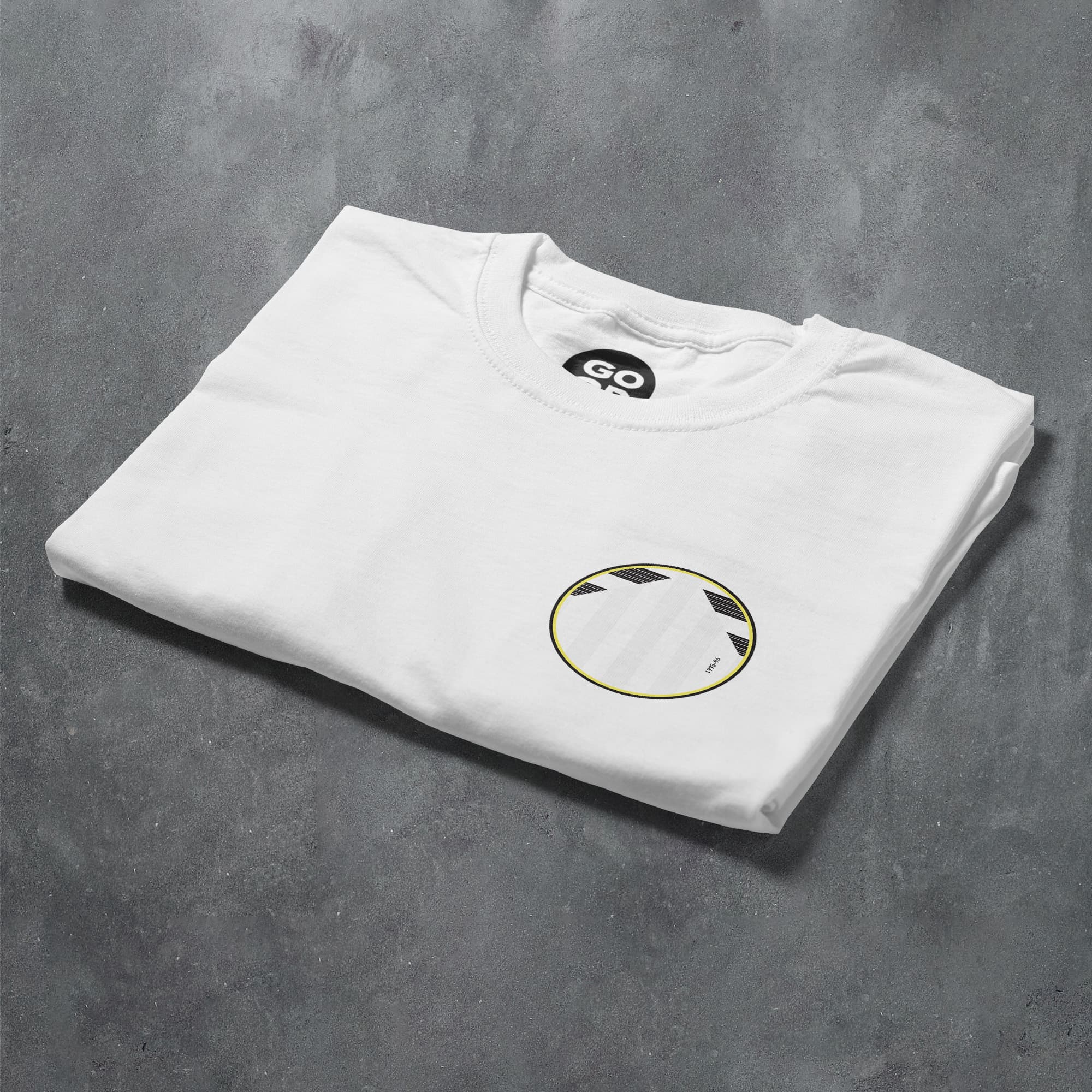 a white t - shirt with a gold circle on the front