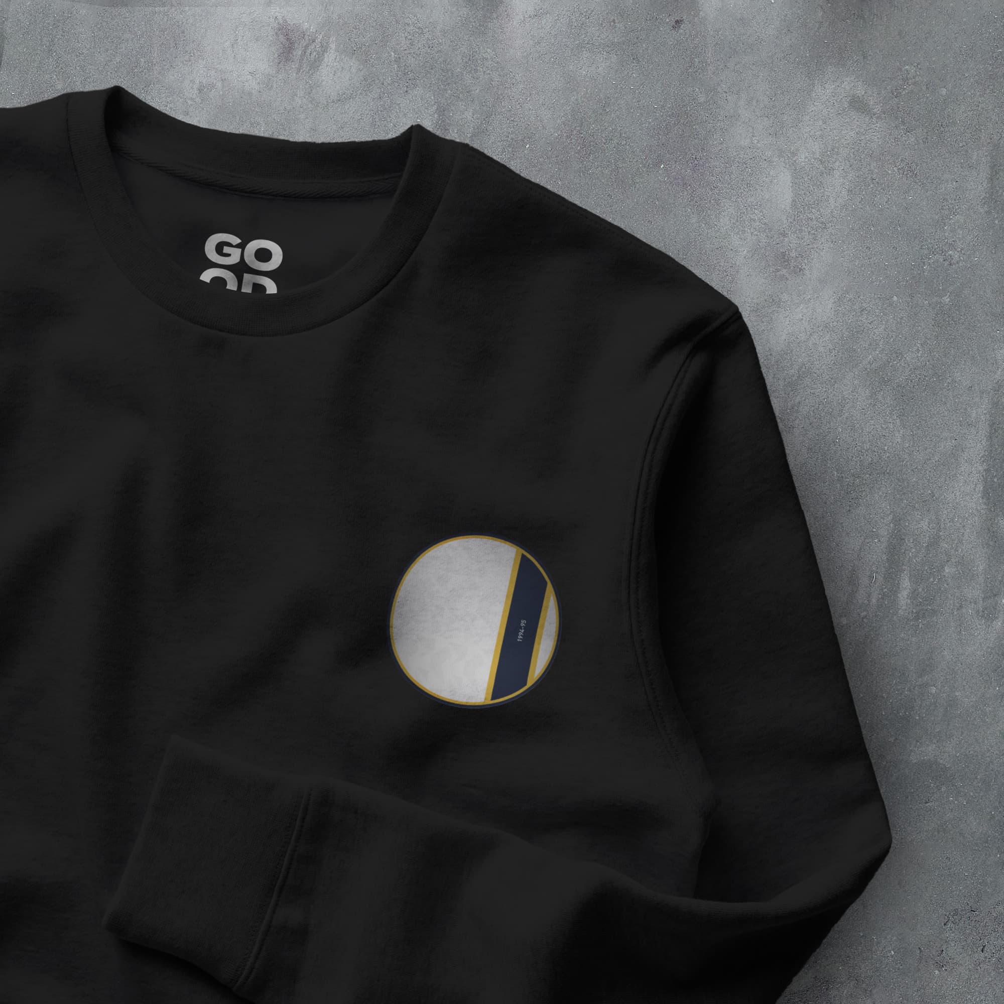 a black sweatshirt with a white circle on it