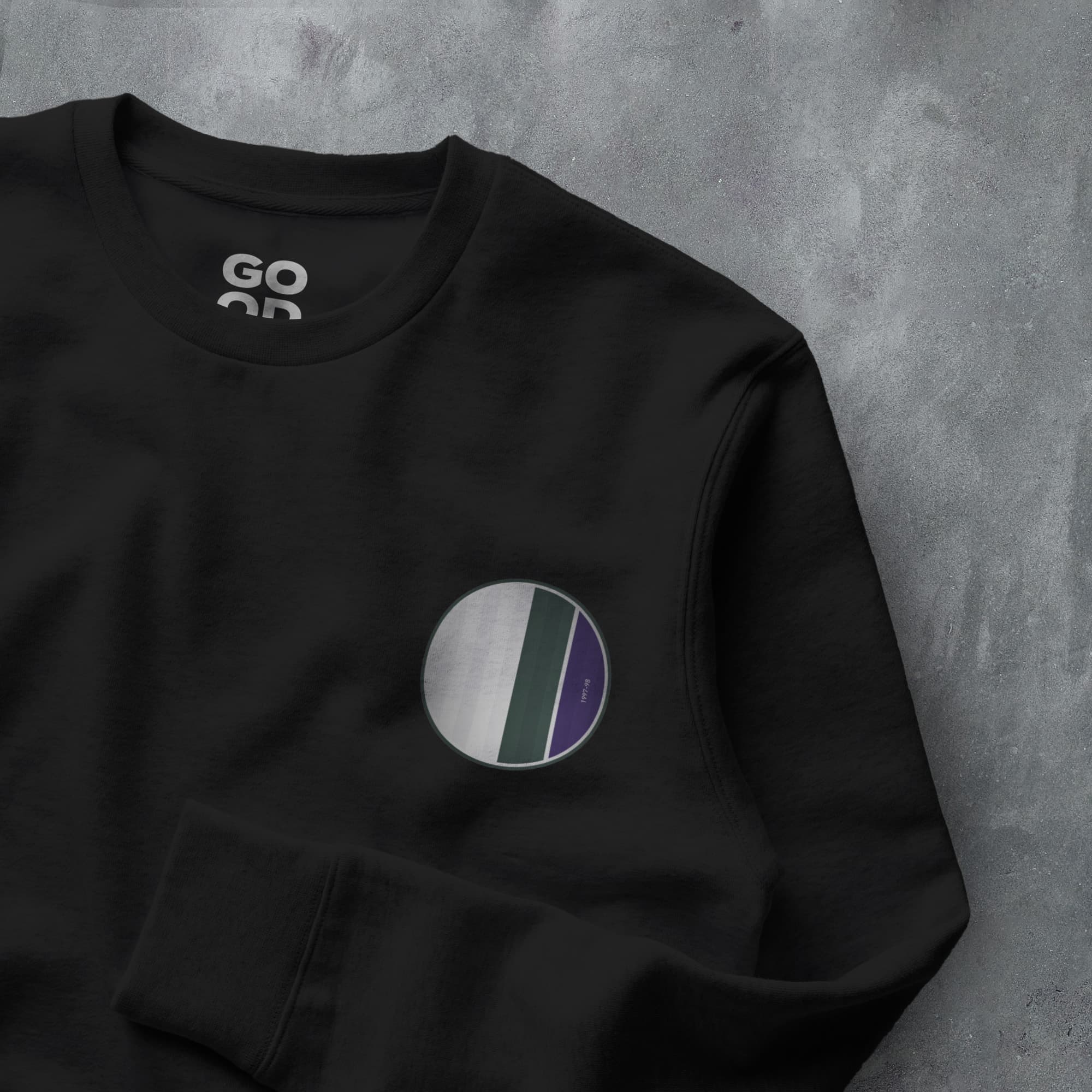 a black sweatshirt with a purple and white circle on it