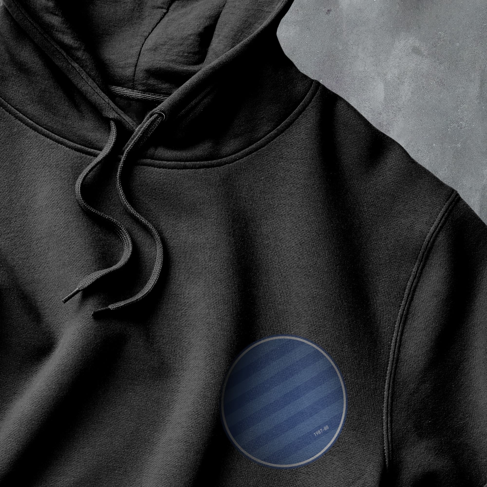 a black hoodie with a blue circle on it