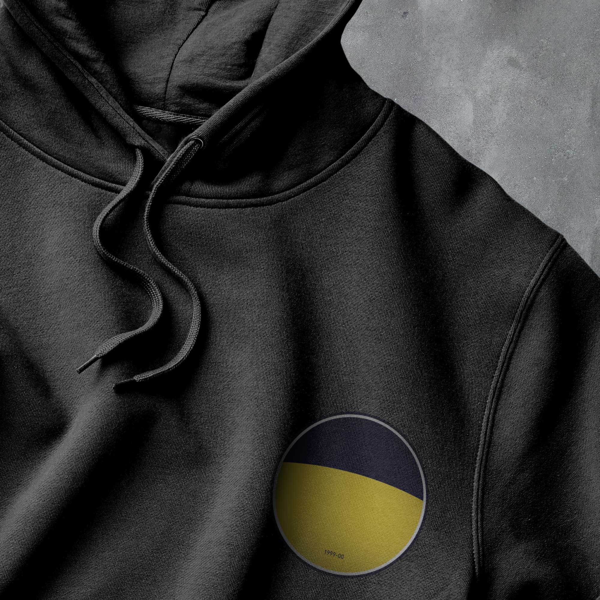 a black hoodie with a yellow and black circle on it