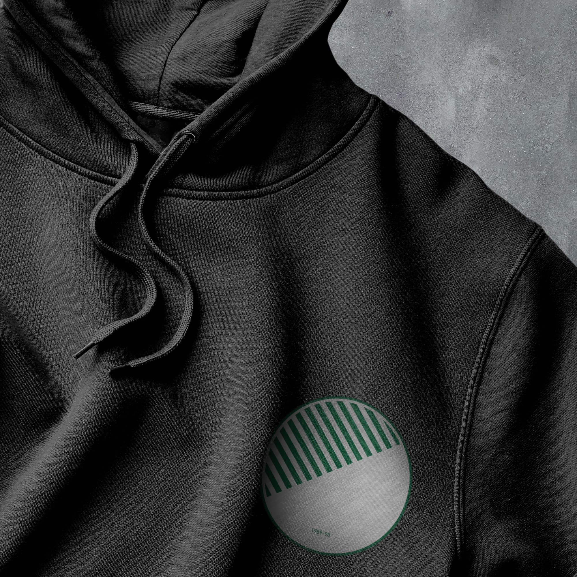 a black hoodie with a green and white circle on it