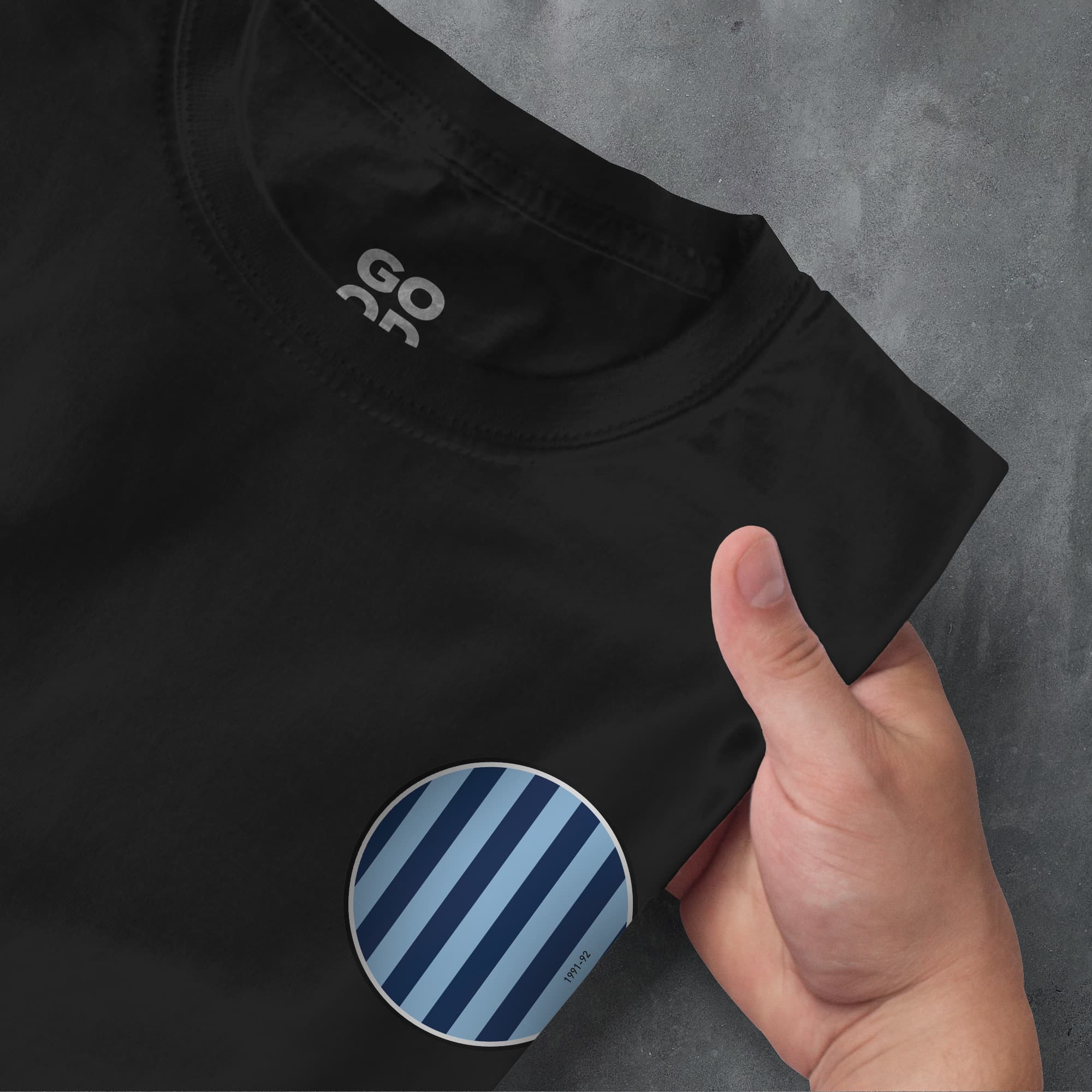 a person pointing at a black shirt with blue stripes