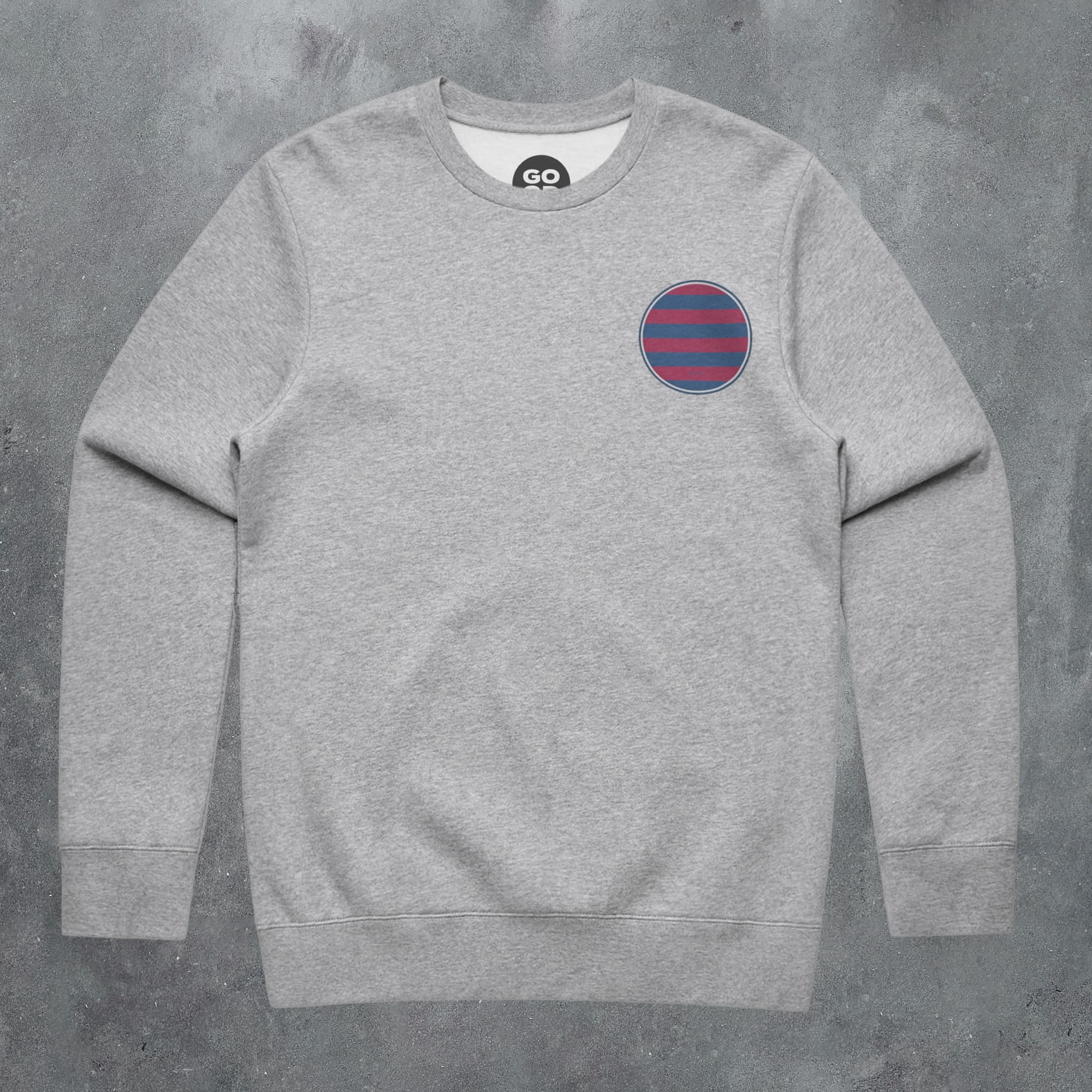 a grey sweatshirt with a blue and red stripe on the chest