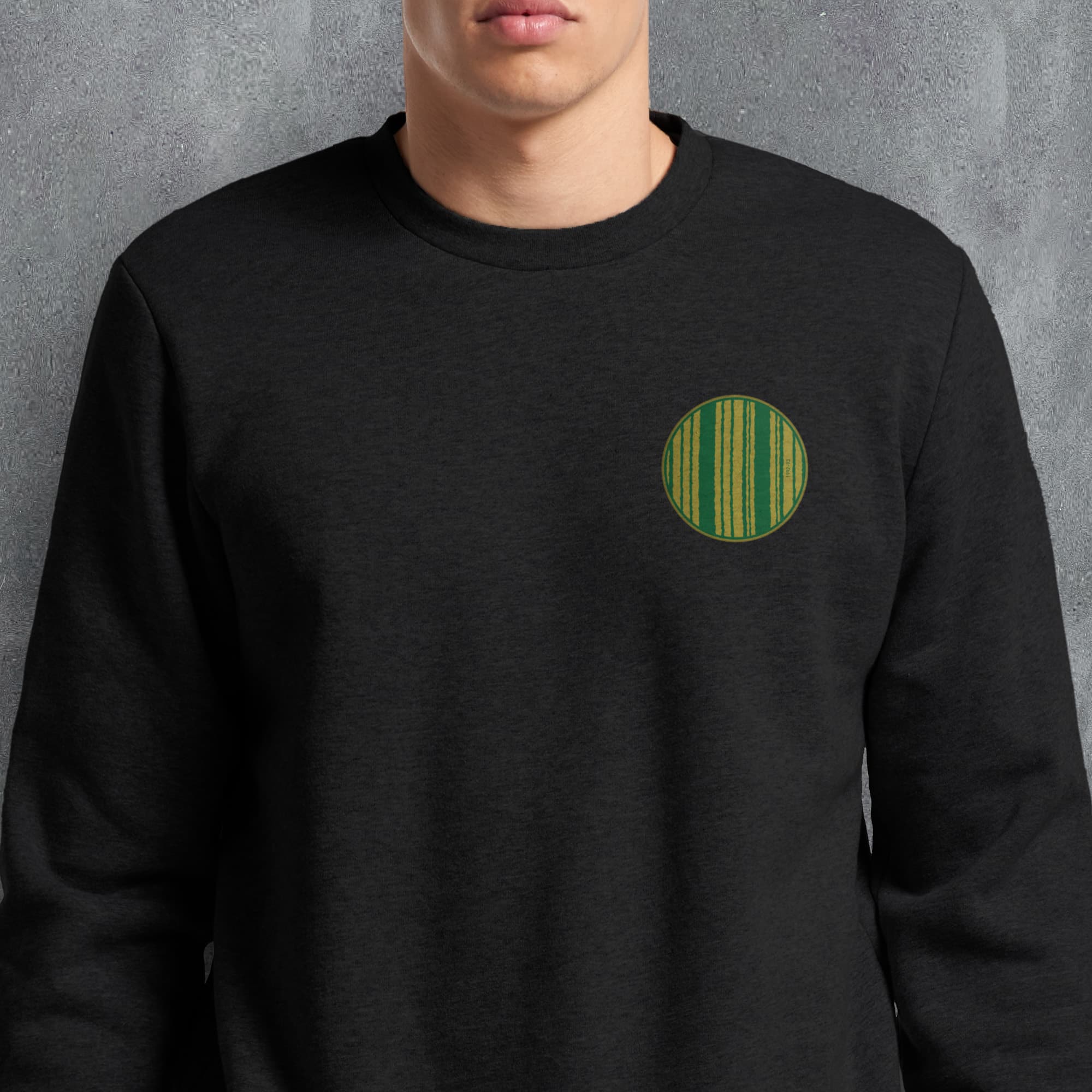 a man wearing a black sweatshirt with a green circle on it