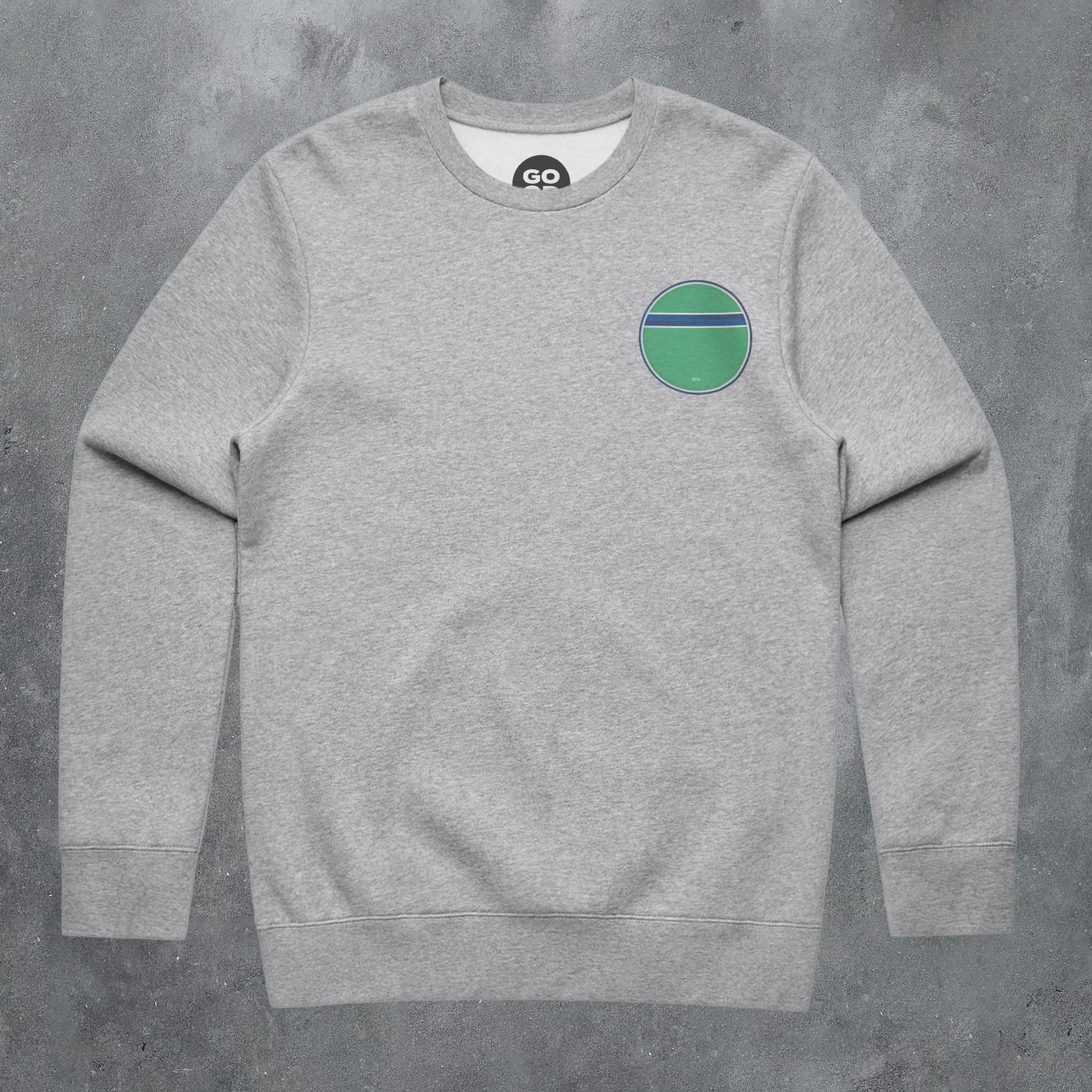 a grey sweatshirt with a green circle on the chest