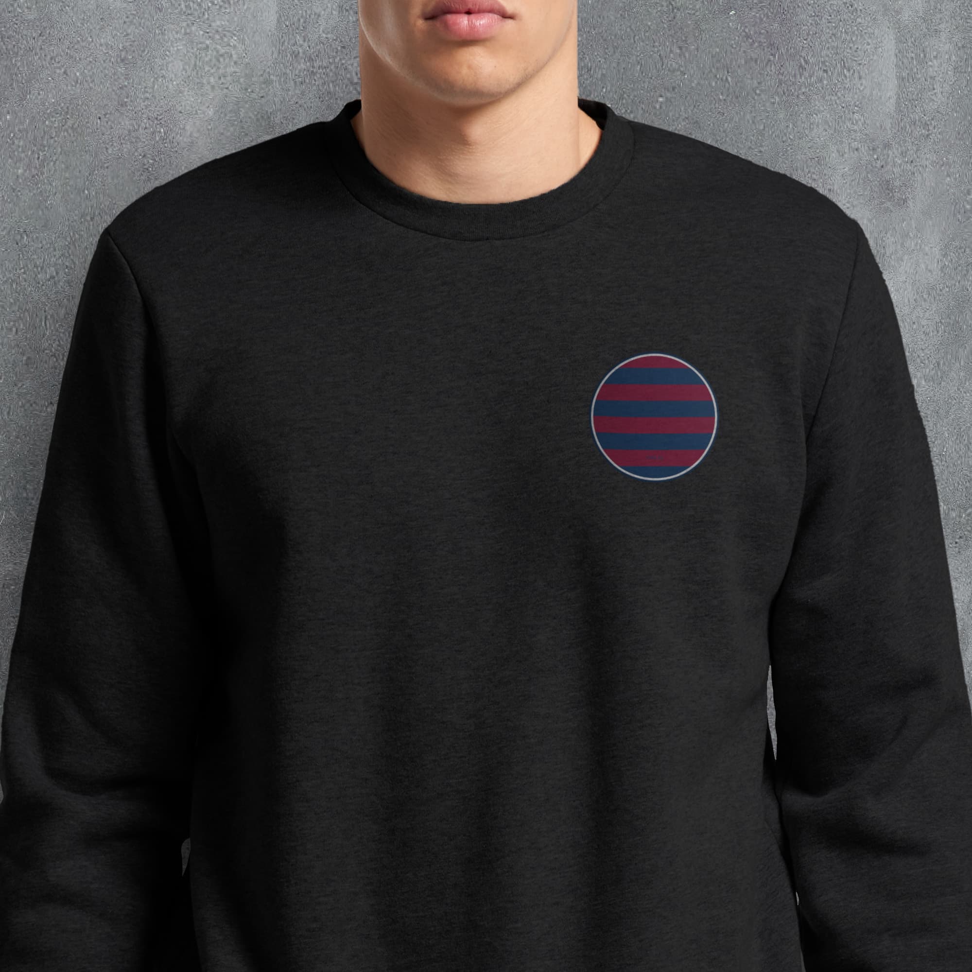 a man wearing a black sweatshirt with a red and blue circle on it