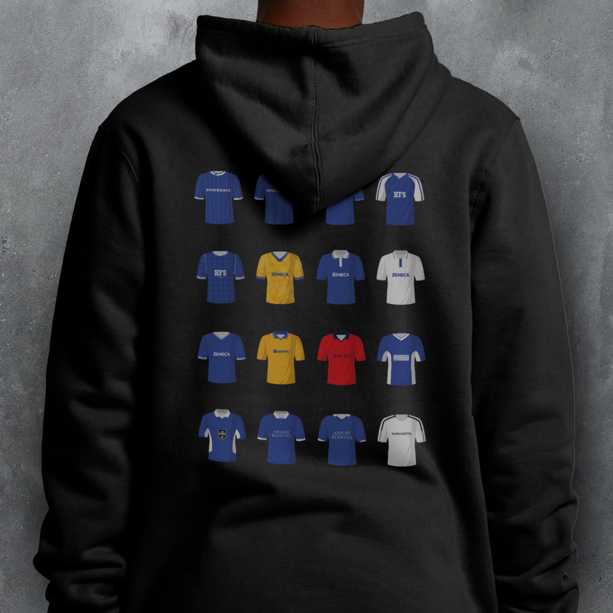 a person wearing a black hoodie with different colored shirts on it