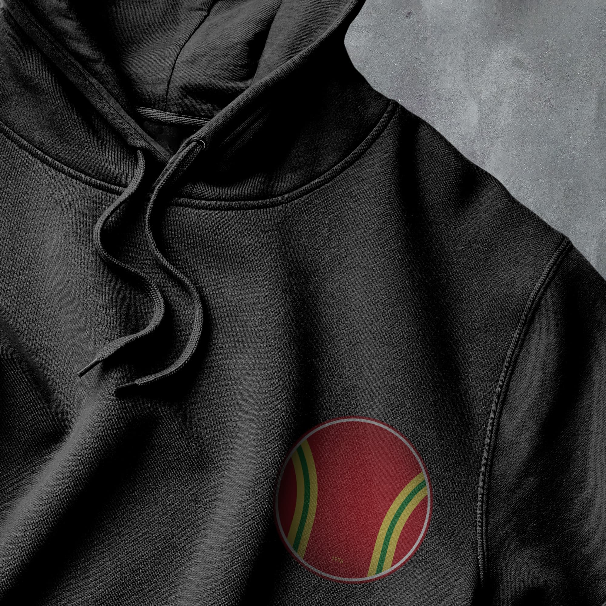 a close up of a black hoodie with a red, yellow and green circle