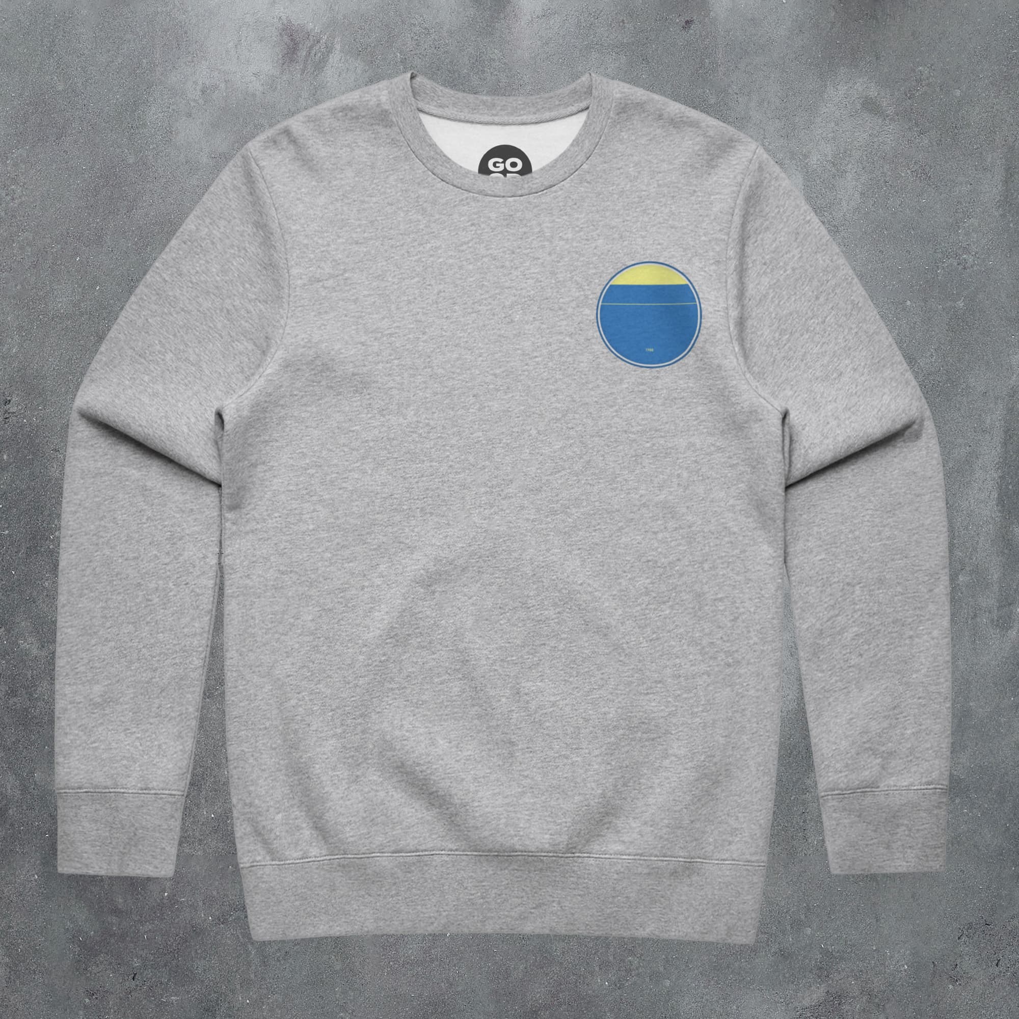 a grey sweatshirt with a blue and yellow circle on it