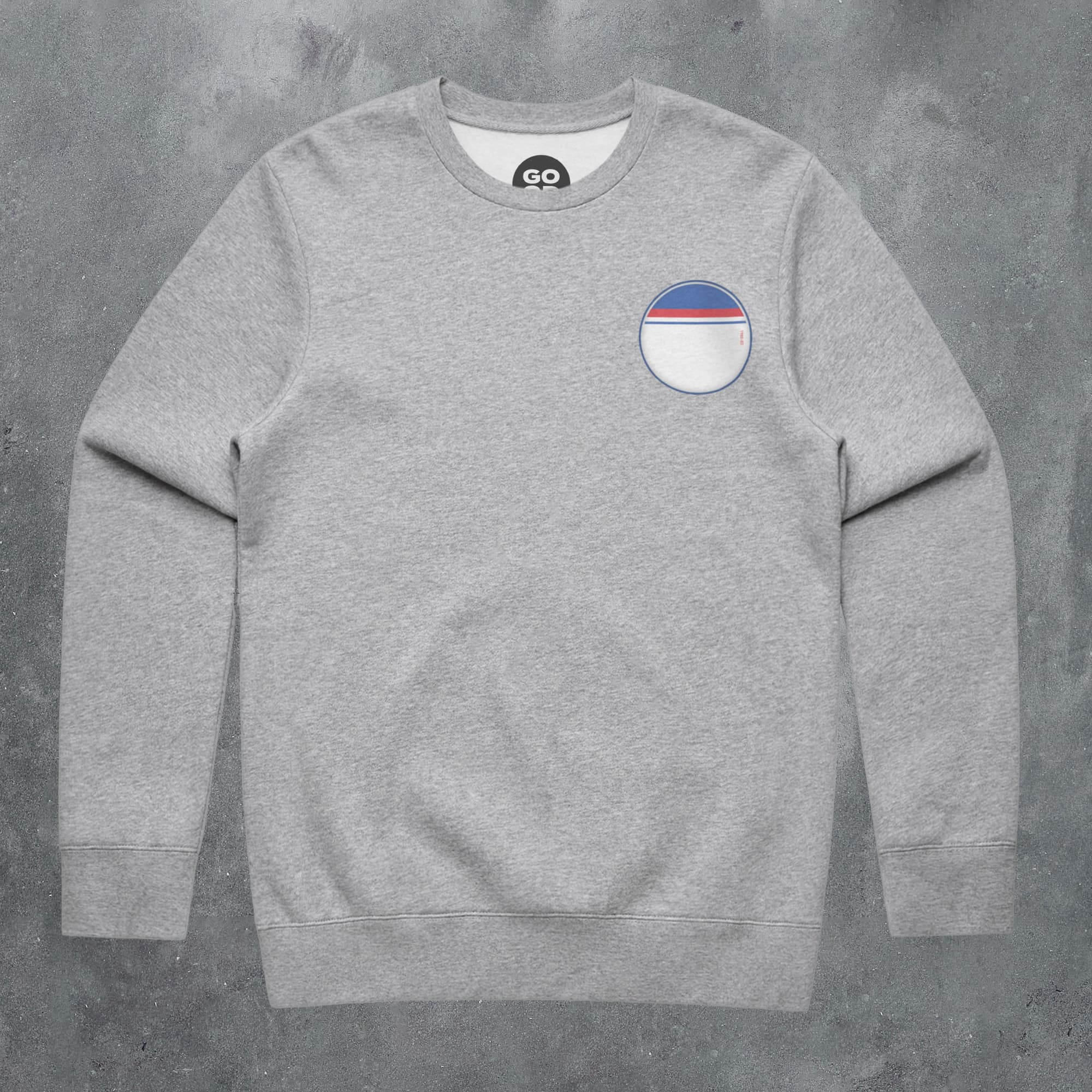 a grey sweatshirt with a blue, white, and red stripe on the chest