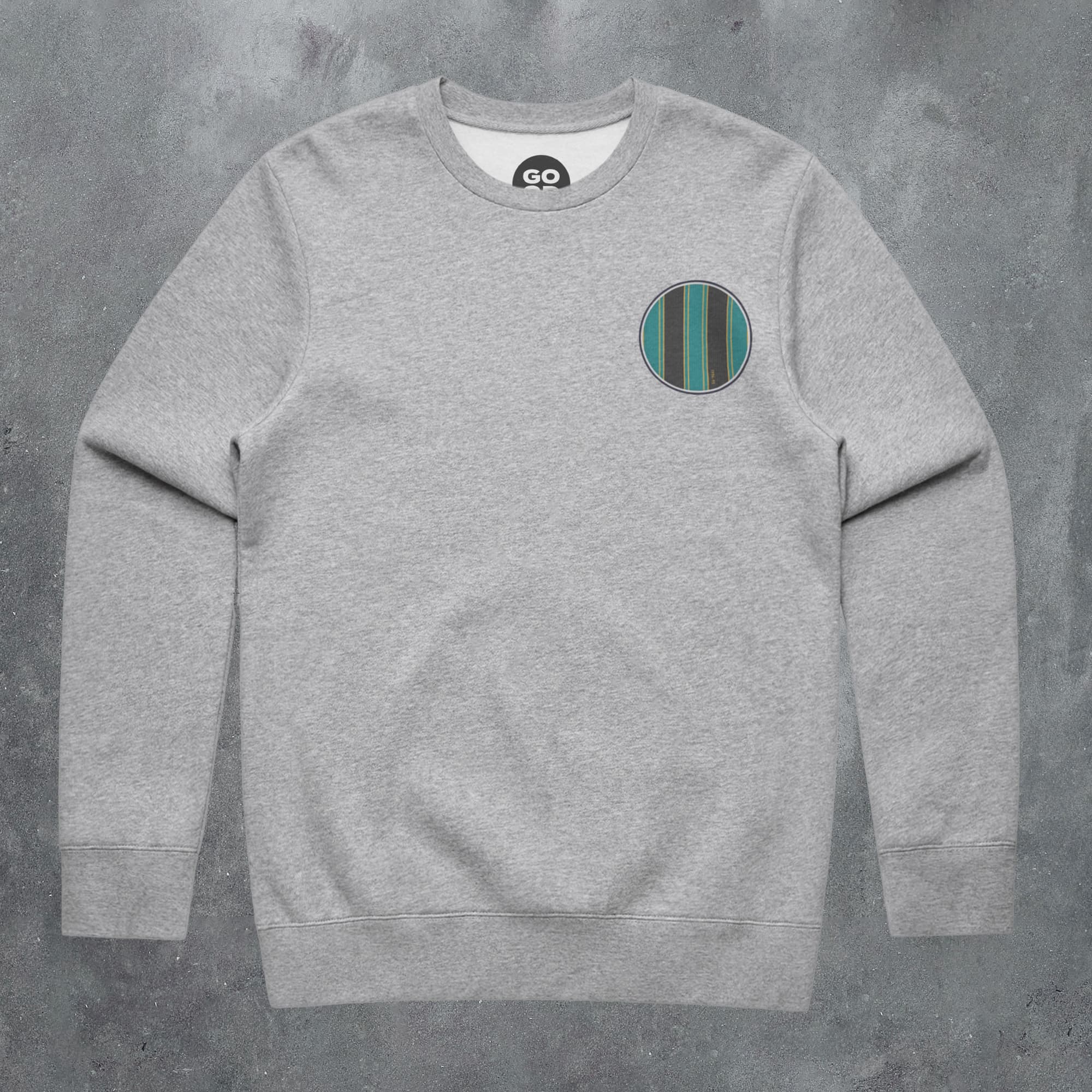 a grey sweatshirt with a green stripe on the chest