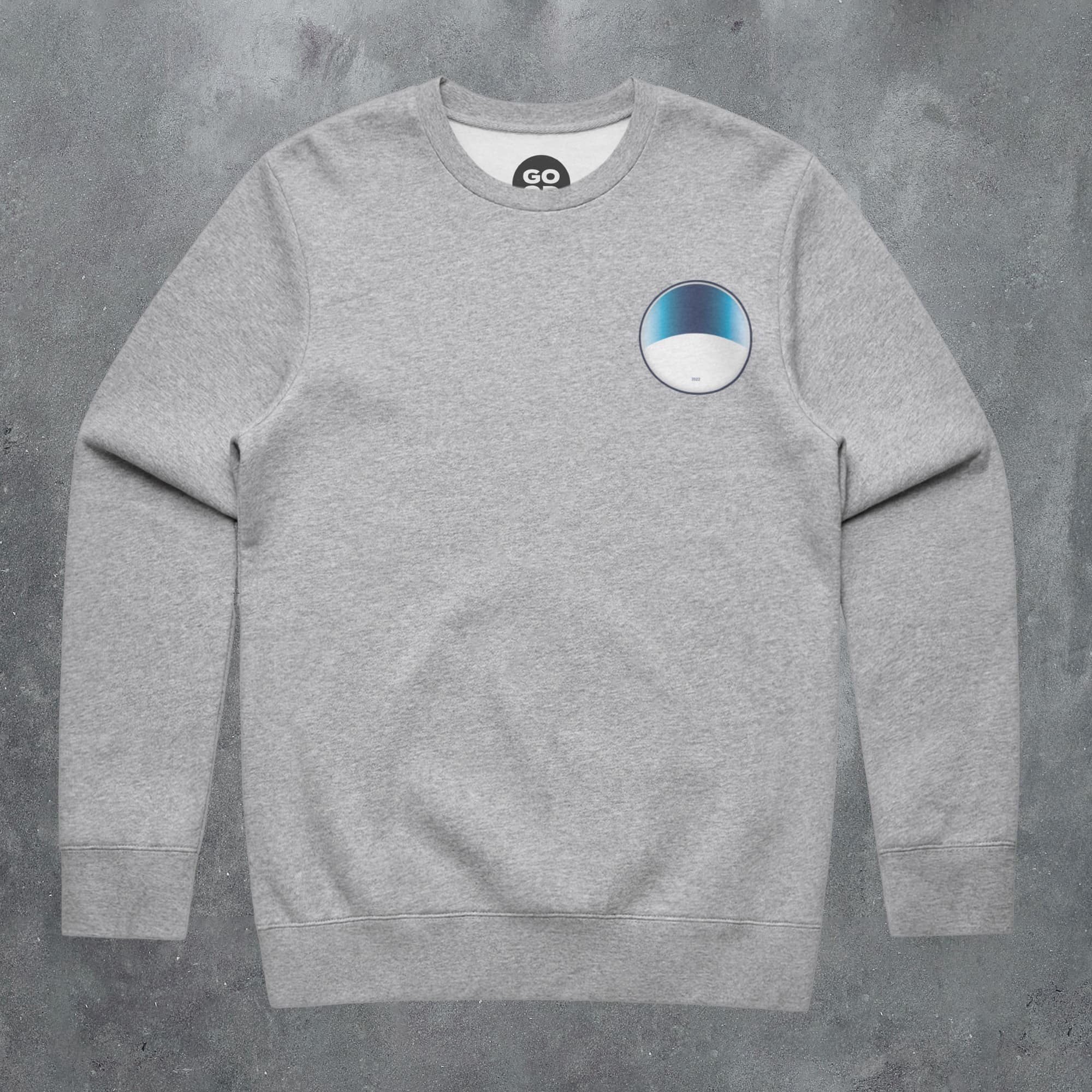 a grey sweatshirt with a blue and white circle on it