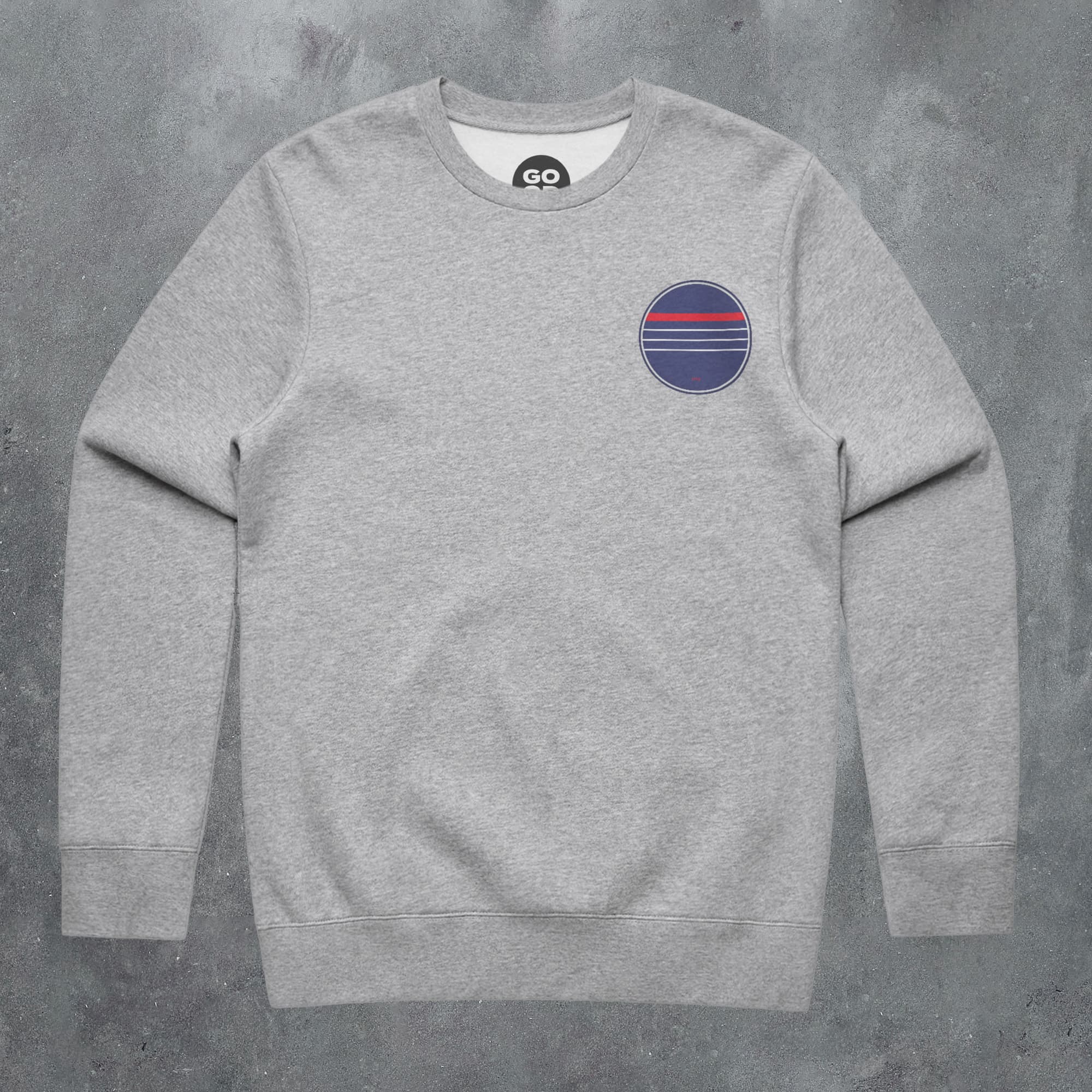 a grey sweatshirt with a red, white and blue stripe on the chest