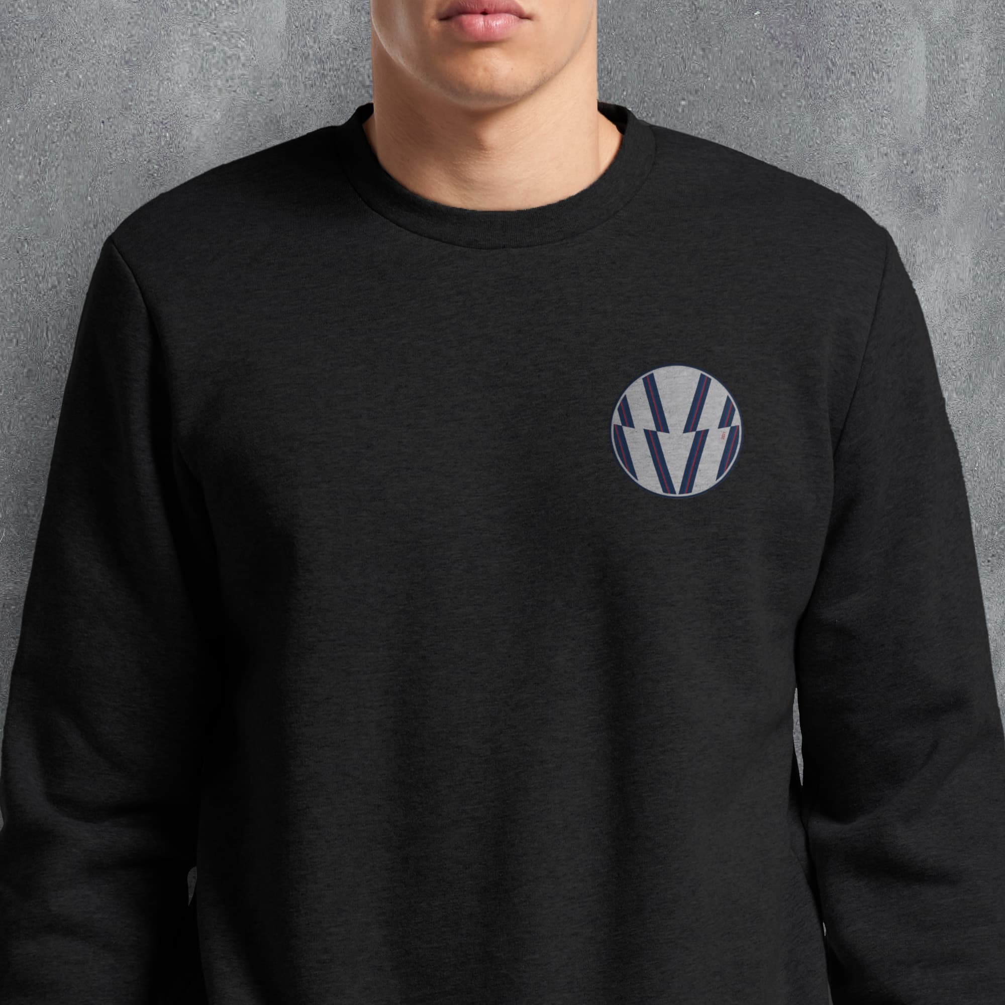 a man wearing a black sweatshirt with a volkswagen emblem on it