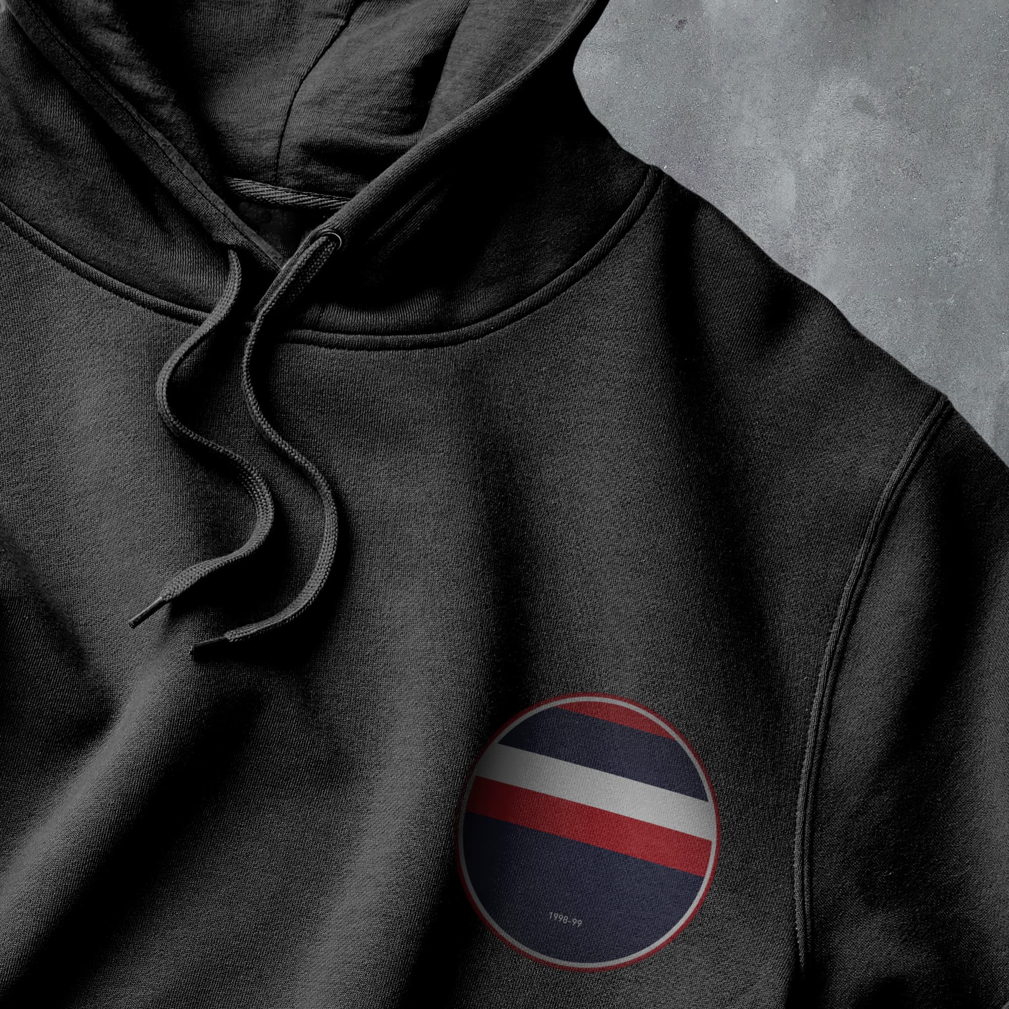 a black hoodie with a red, white, and blue stripe on it