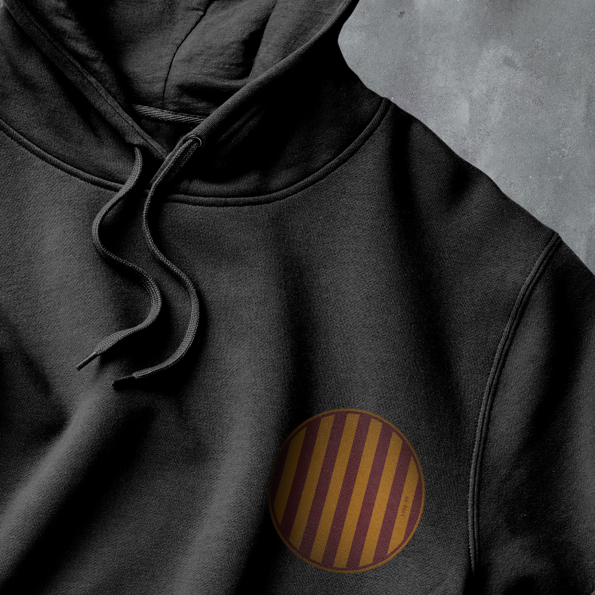 a close up of a black hoodie with a brown stripe on it