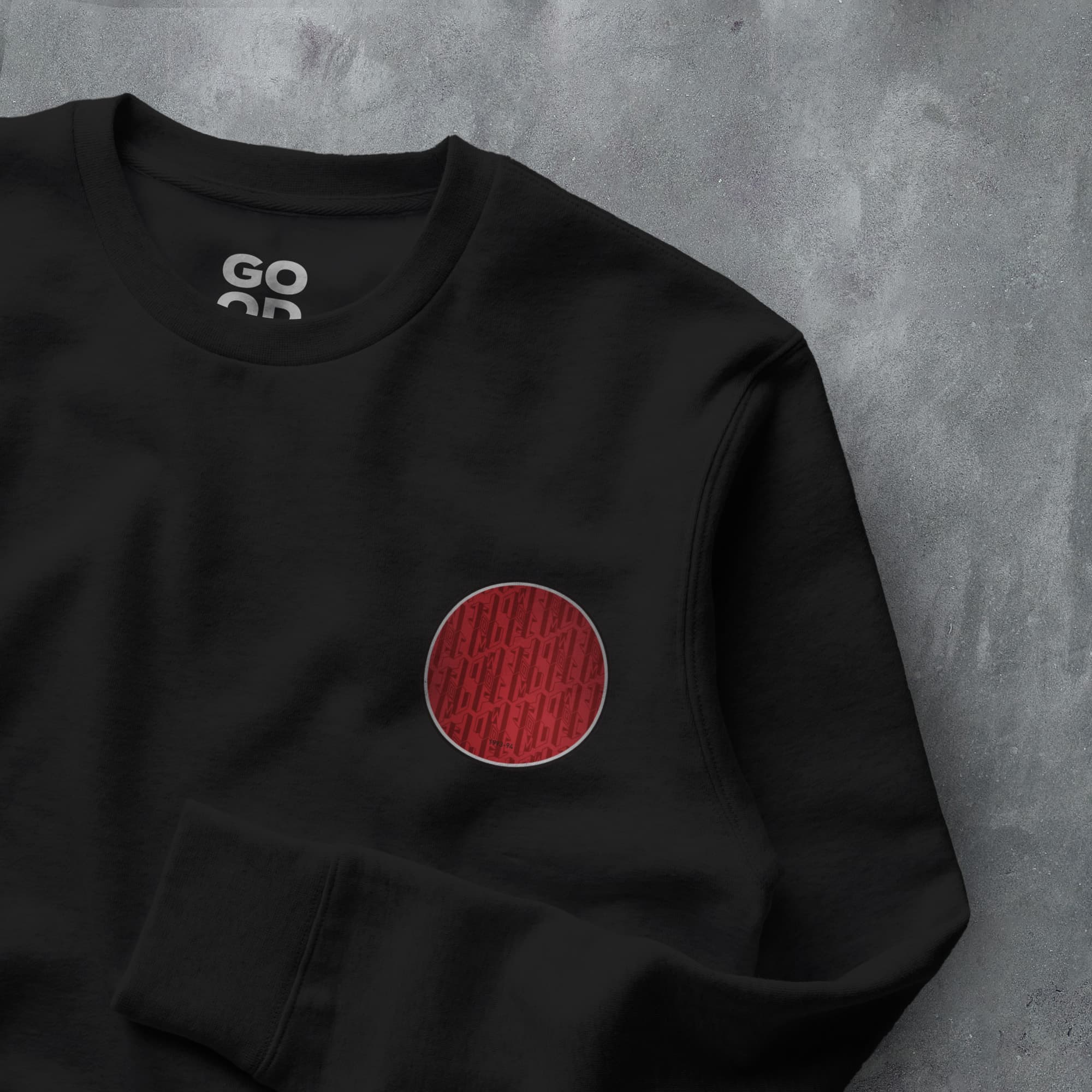 a black sweatshirt with a red circle on it