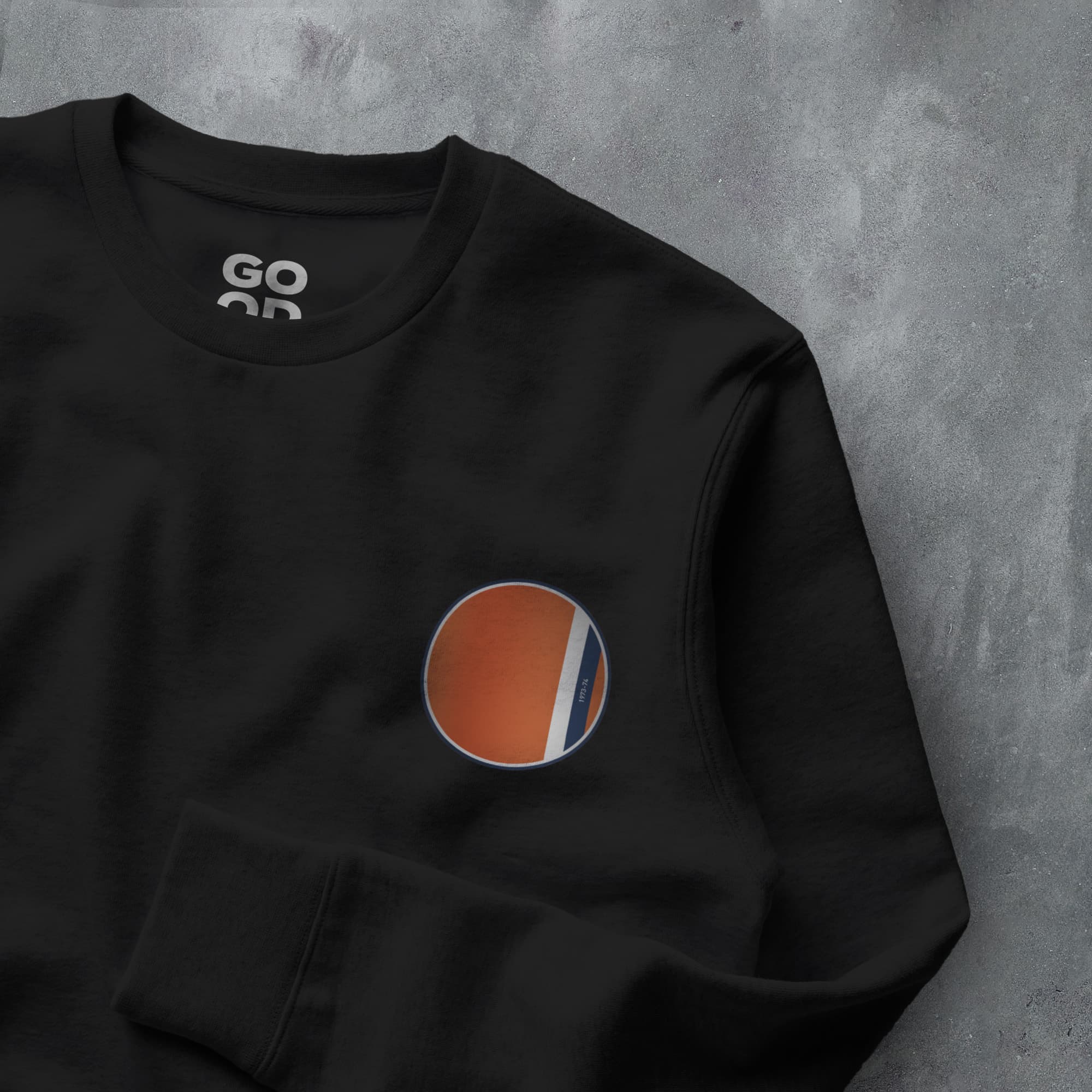 a black sweatshirt with an orange and blue circle on it
