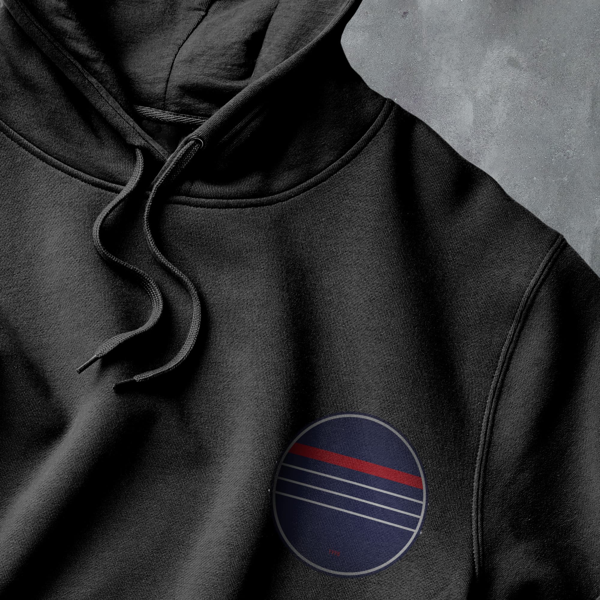 a black hoodie with a red, white, and blue circle on it