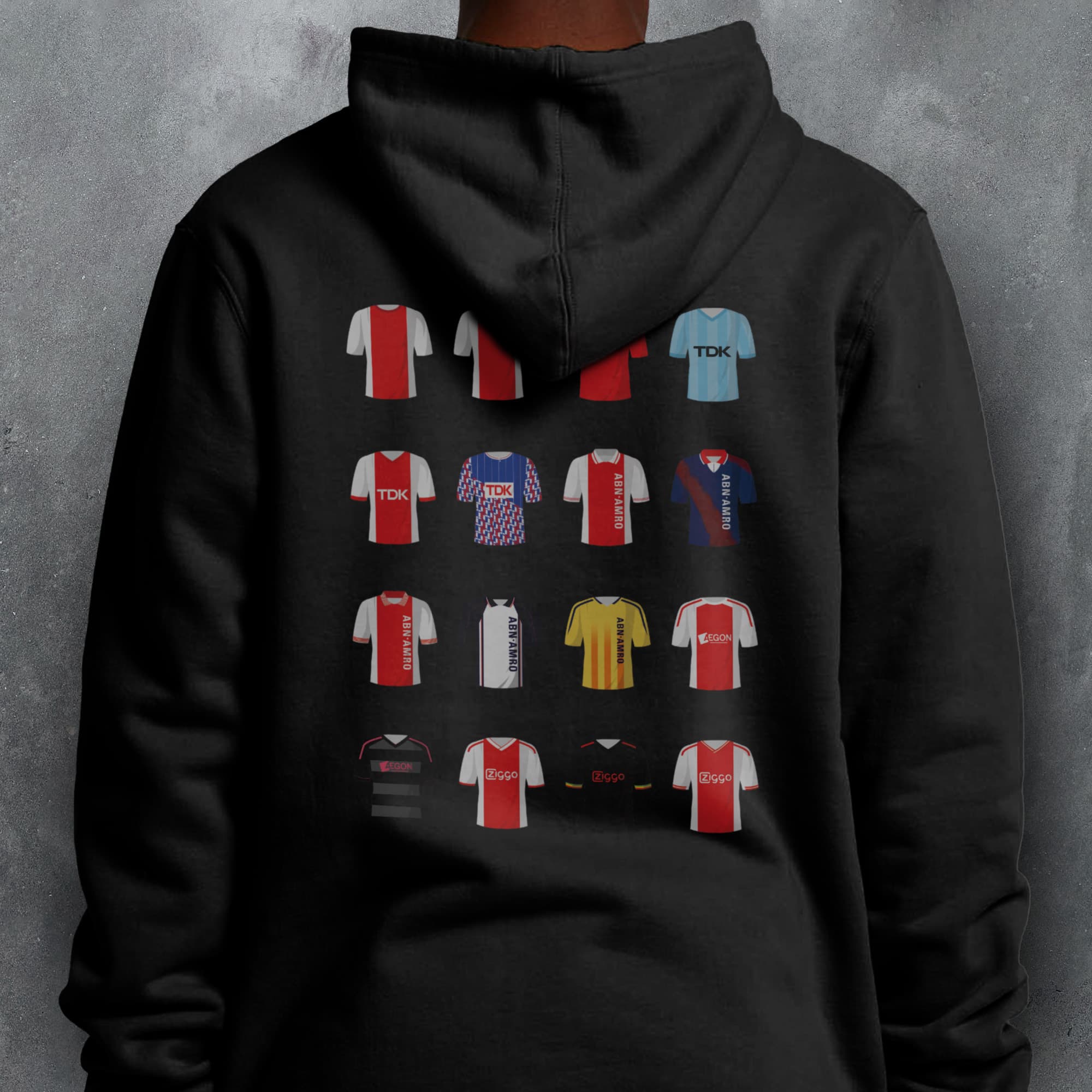 a person wearing a black hoodie with different colored shirts on it