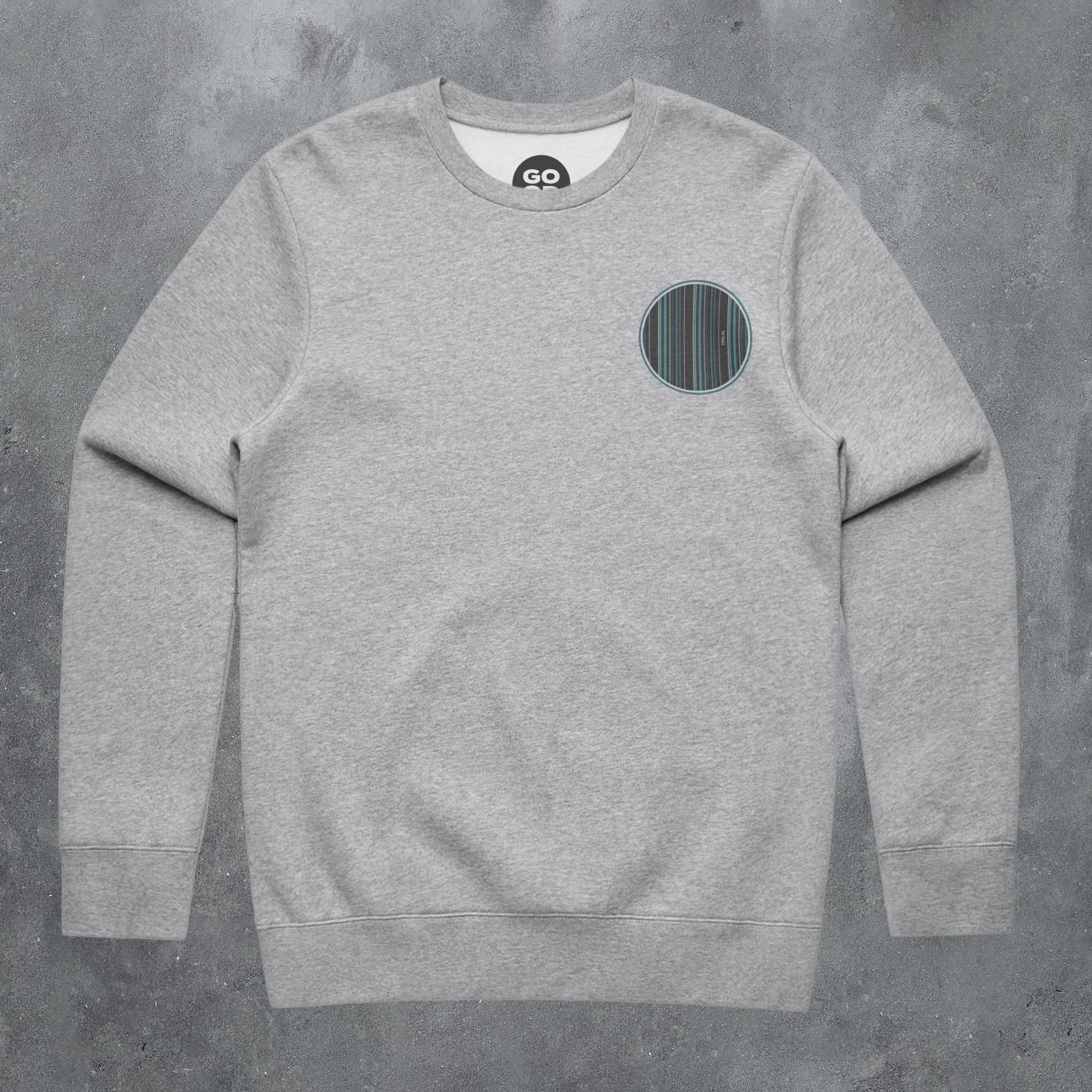 a grey sweatshirt with a black circle on the front