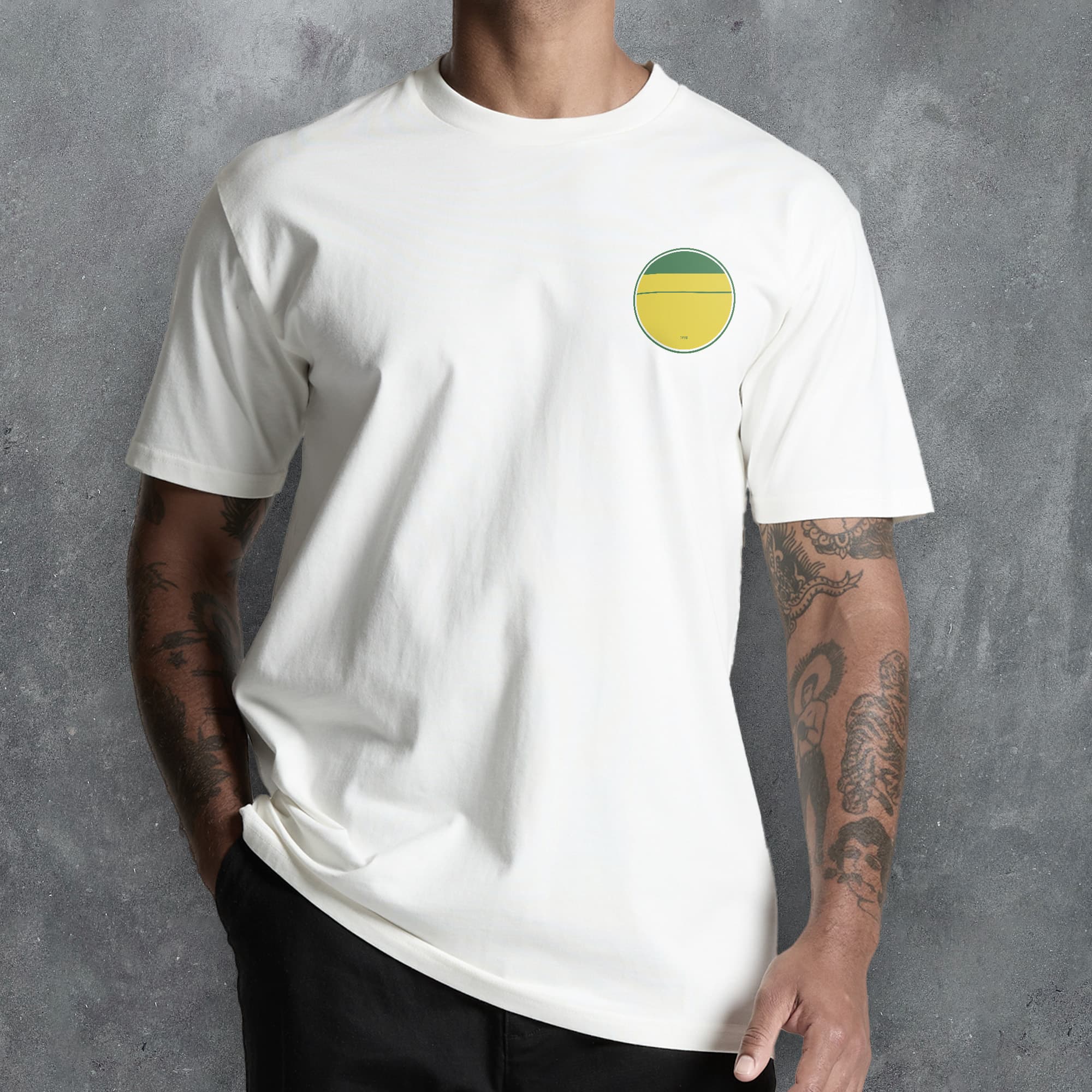 a man wearing a white t - shirt with a yellow and green circle on the