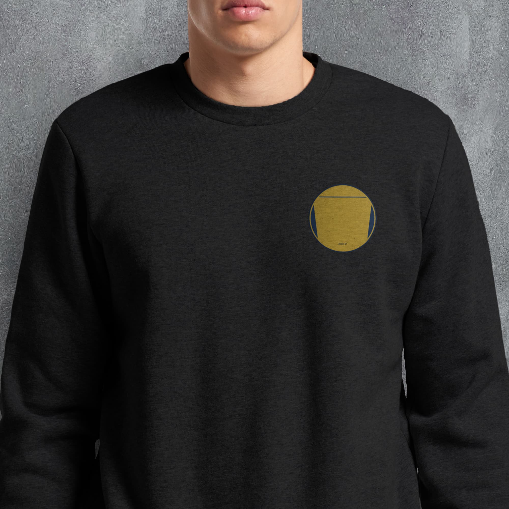 a man wearing a black sweatshirt with a yellow circle on it