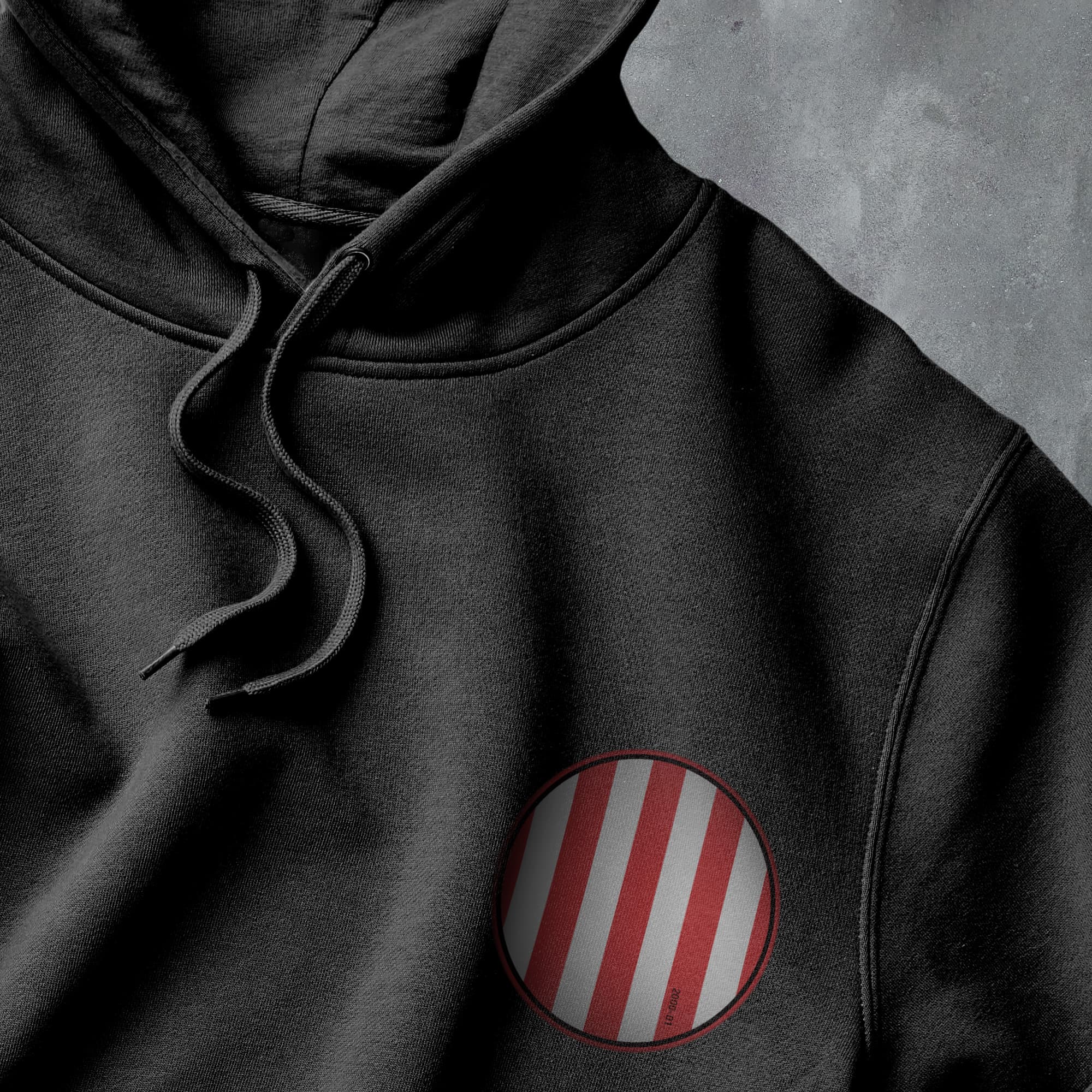 a black hoodie with a red and white stripe on it