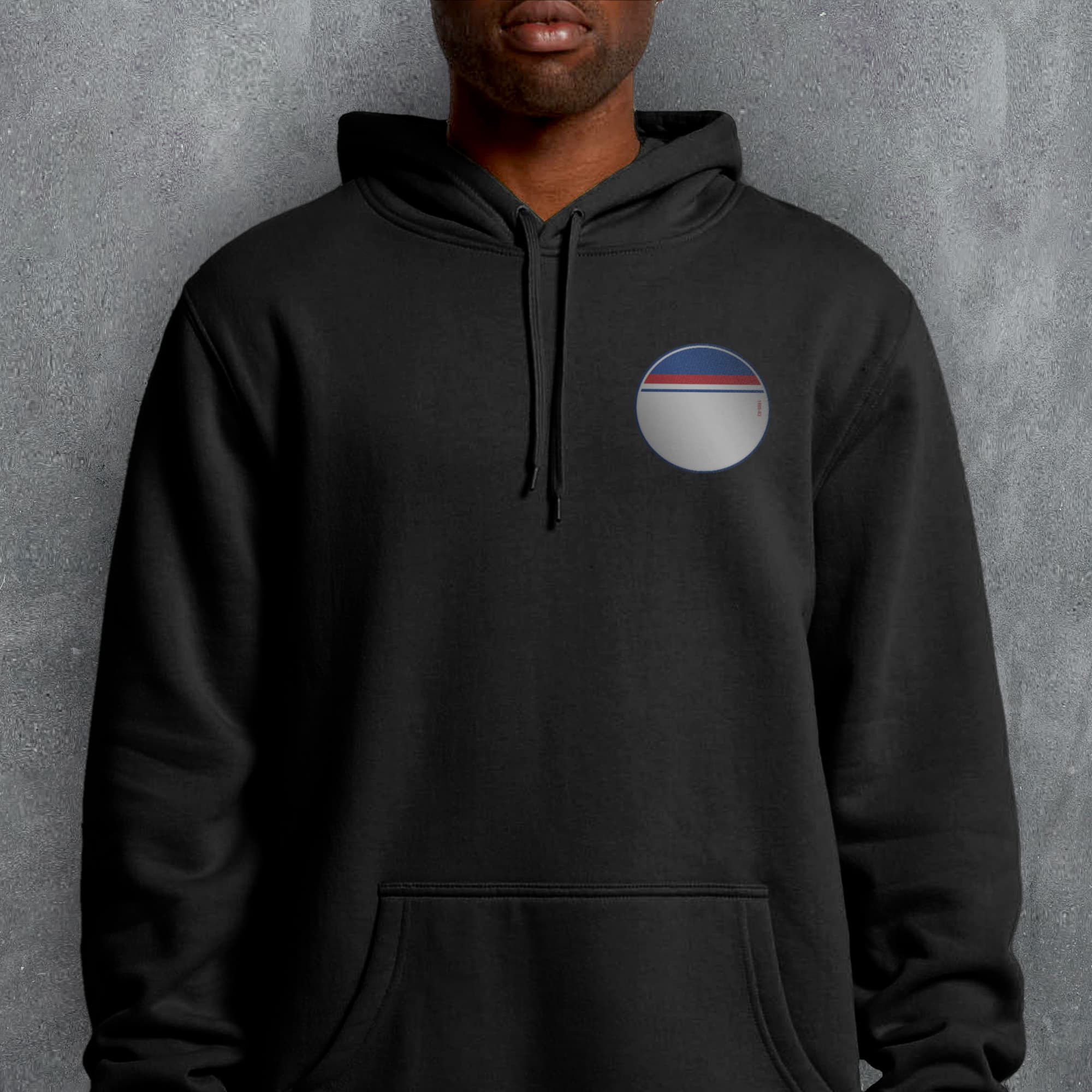 a man wearing a black hoodie with a pepsi logo on it
