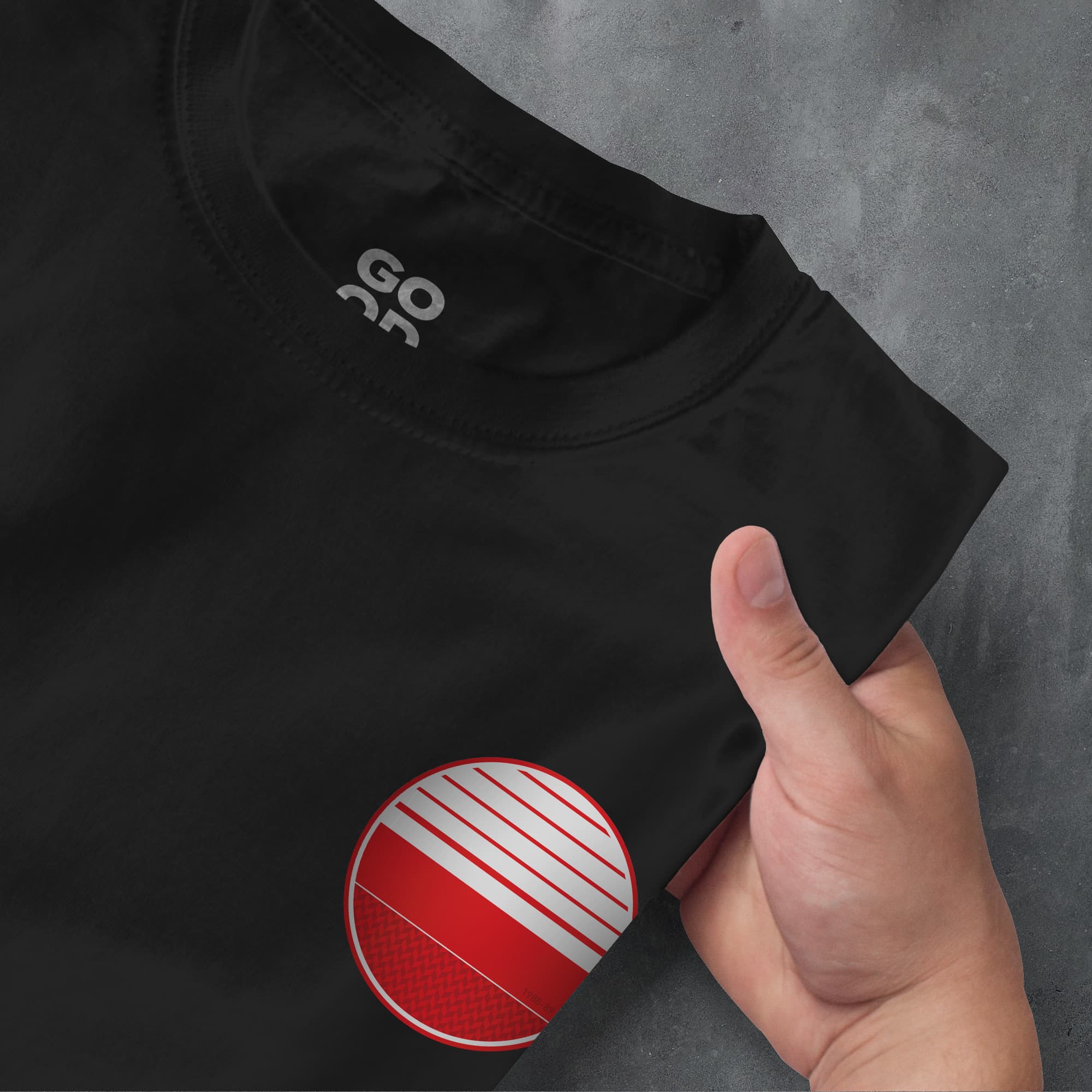 a hand pointing at a black shirt with red and white stripes