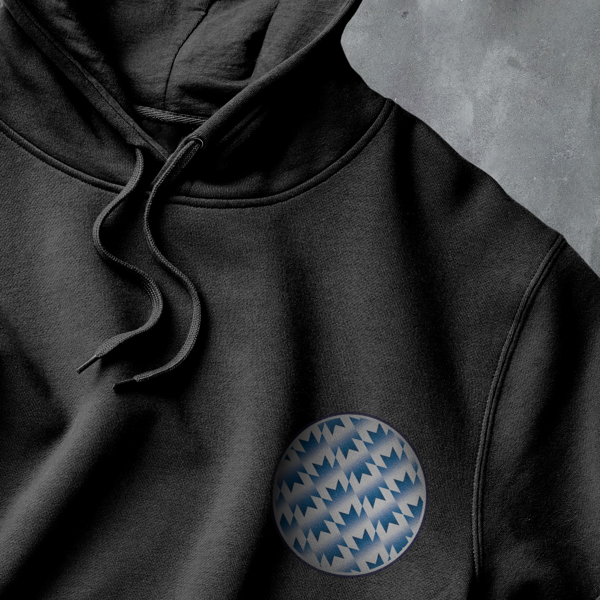 a black hoodie with a blue and white pattern on it