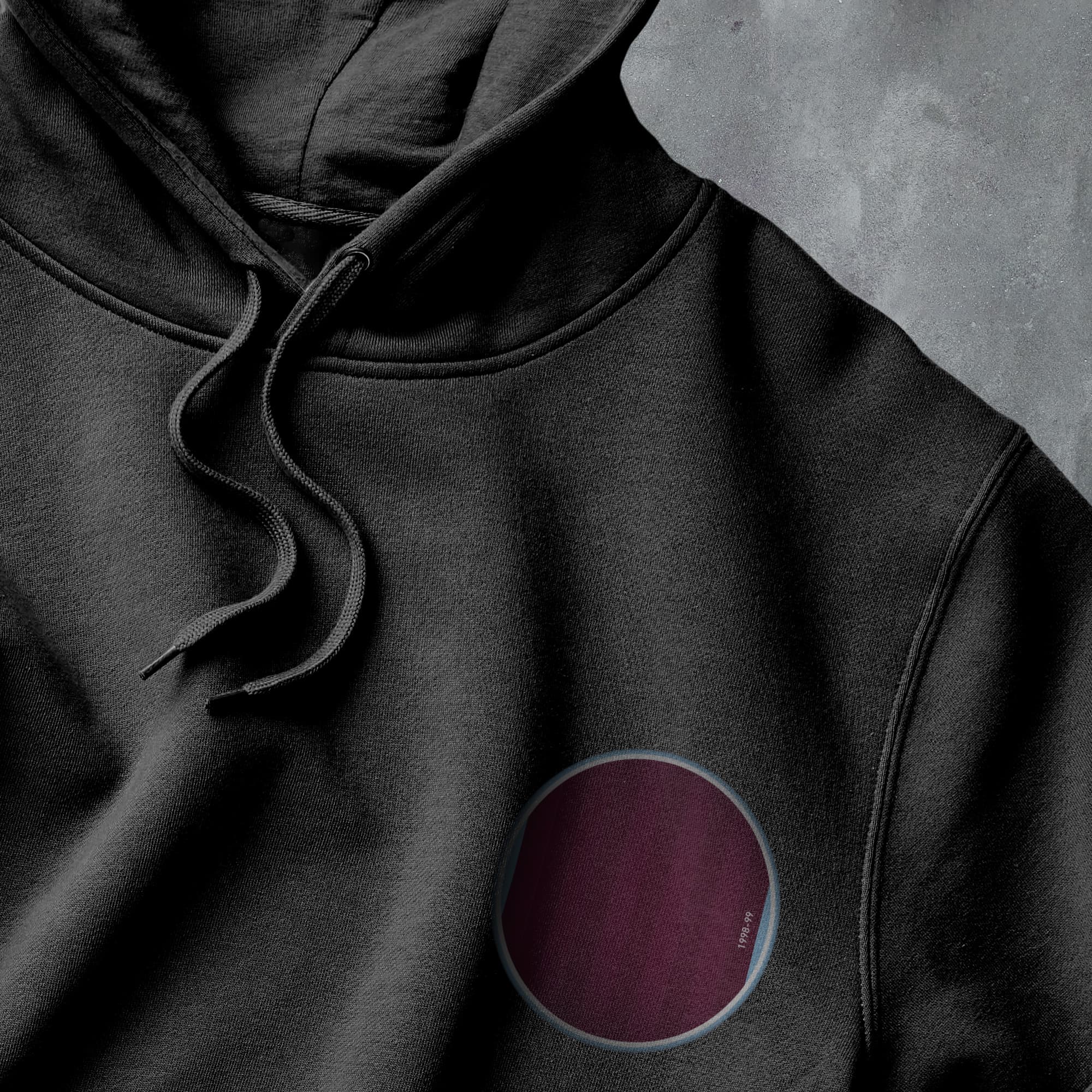 a black hoodie with a red circle on it