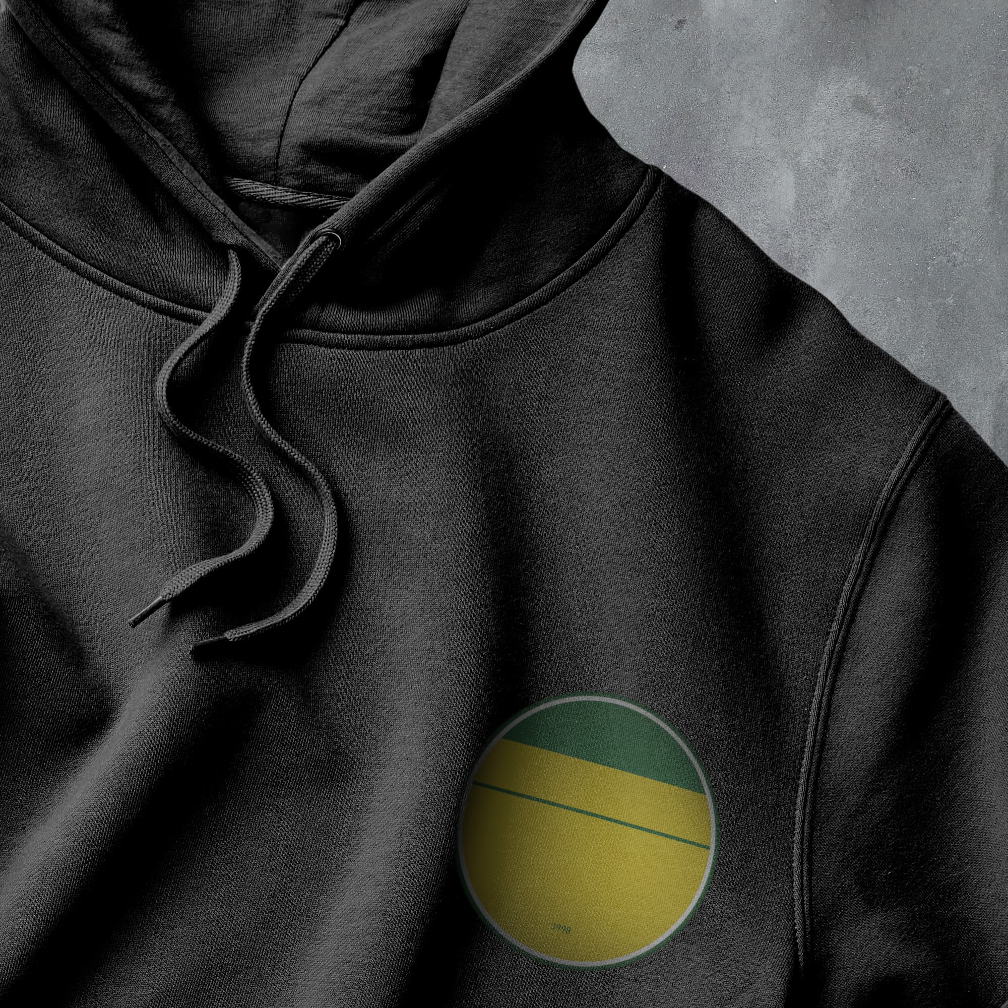 a black hoodie with a yellow and green circle on it