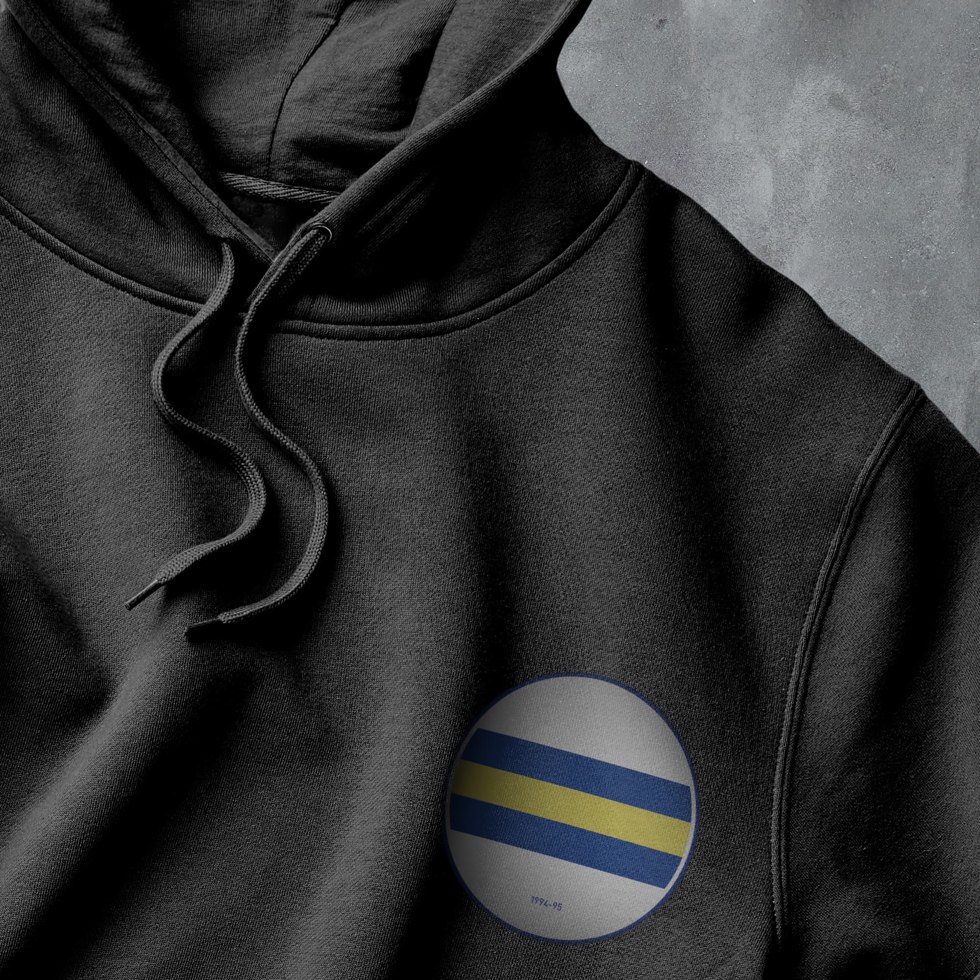 a black hoodie with a blue and yellow stripe on it