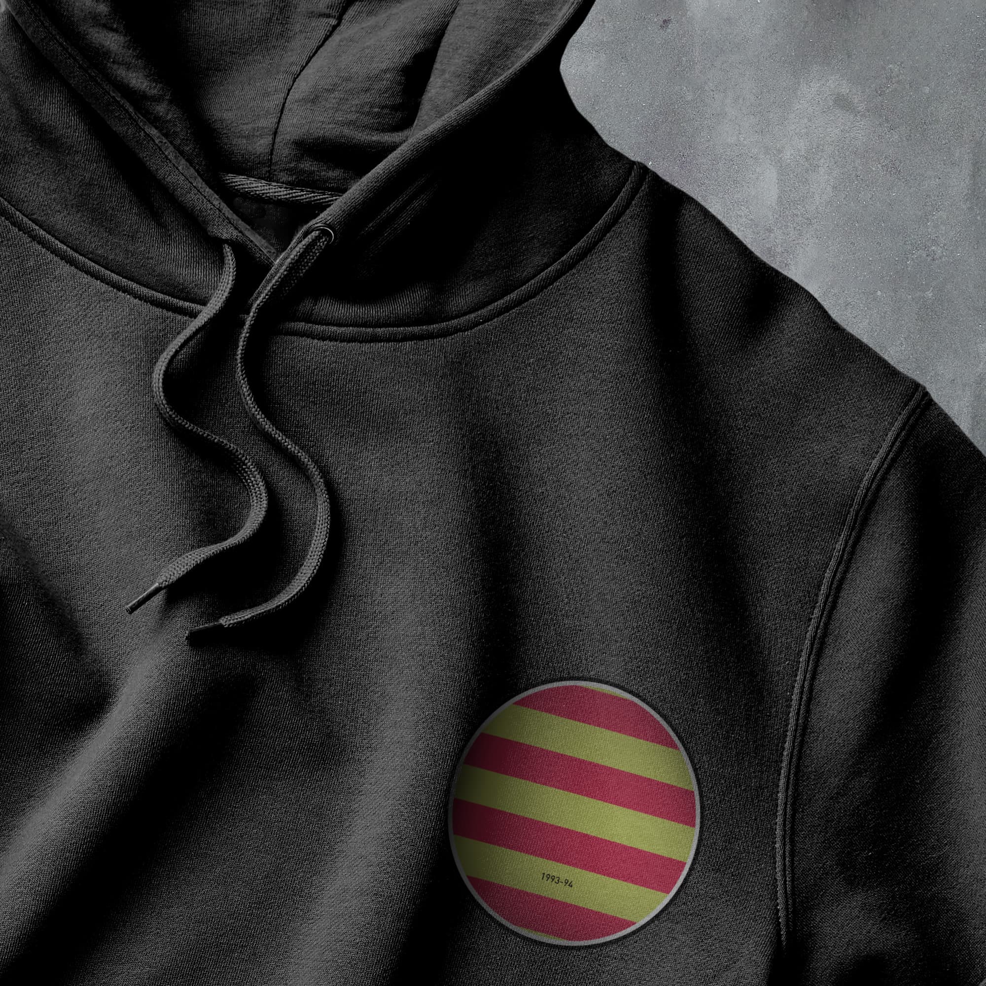 a black hoodie with a red, yellow, and green stripe on it